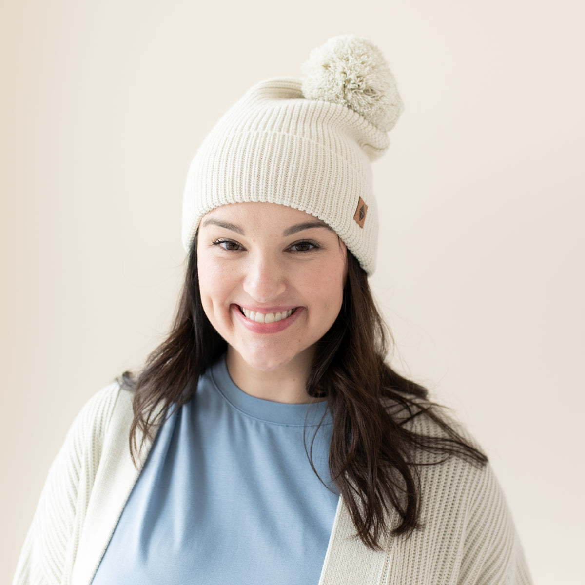 Woman modeling Chunky Knit Adult Pom Beanie in Oat 