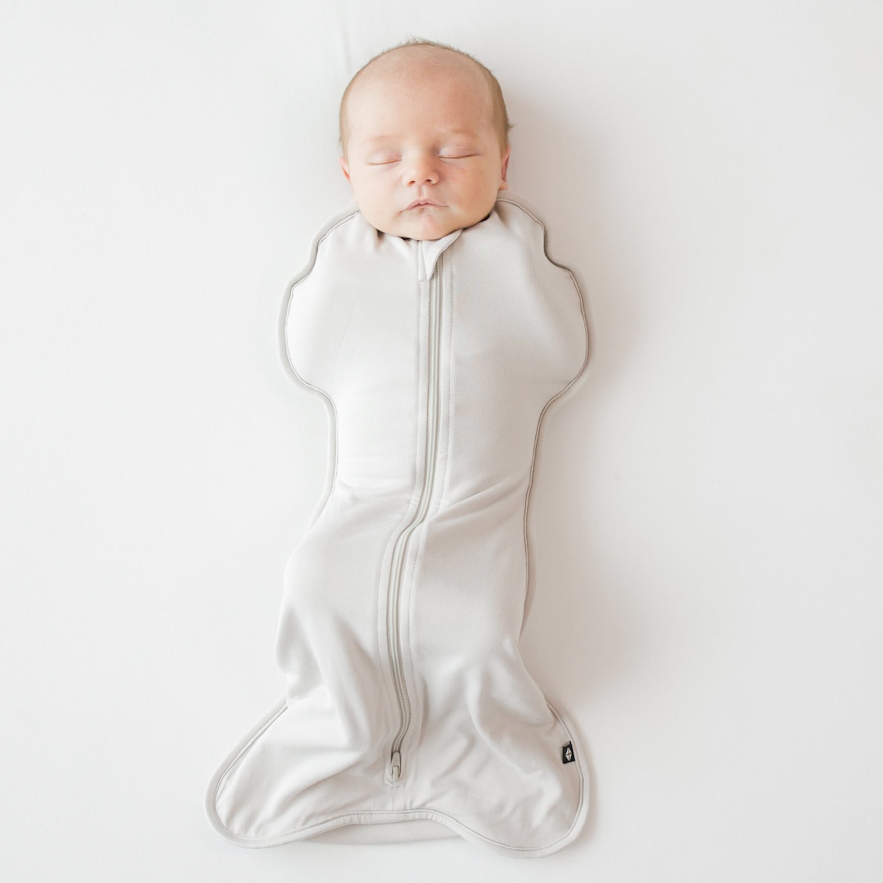 Baby sleeping in Kyte Baby Swaddle Bag in Oat 0.5