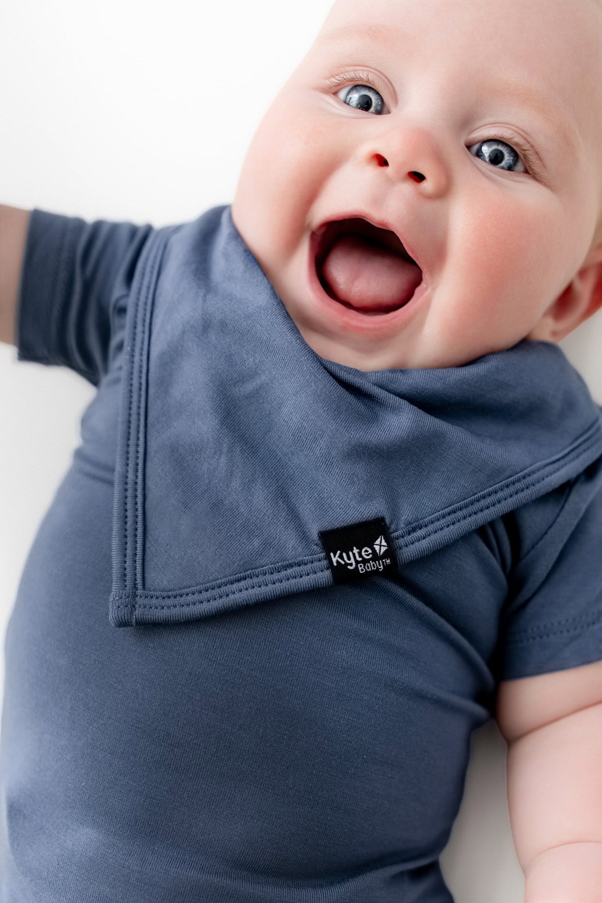 Baby wearing Bib in Oxford over similar color bodysuit