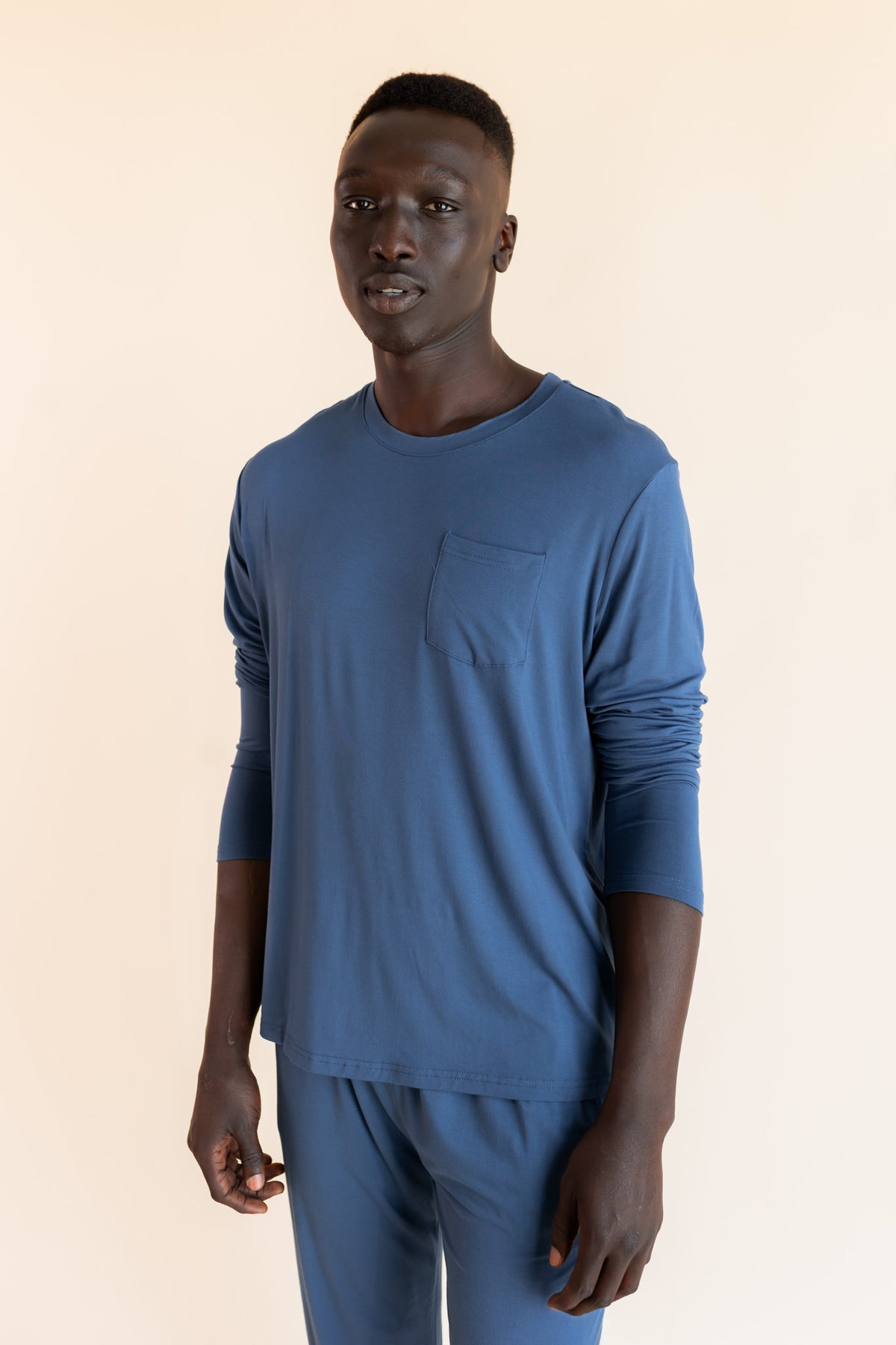 Model wearing Men's Jogger Set in Oxford on a beige background
