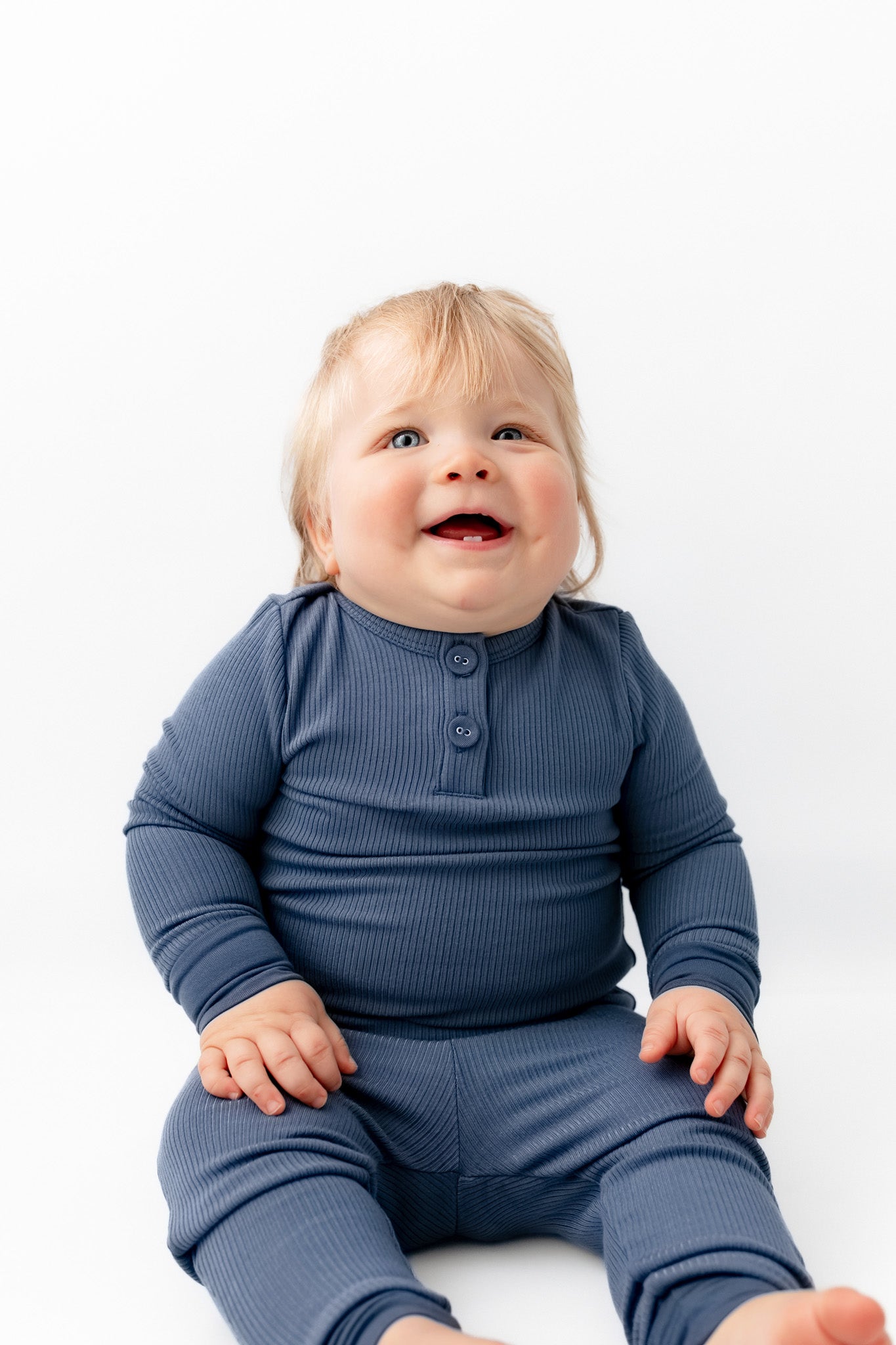 Baby sitting in Ribbed Infant Henley Set in Oxford on a white background