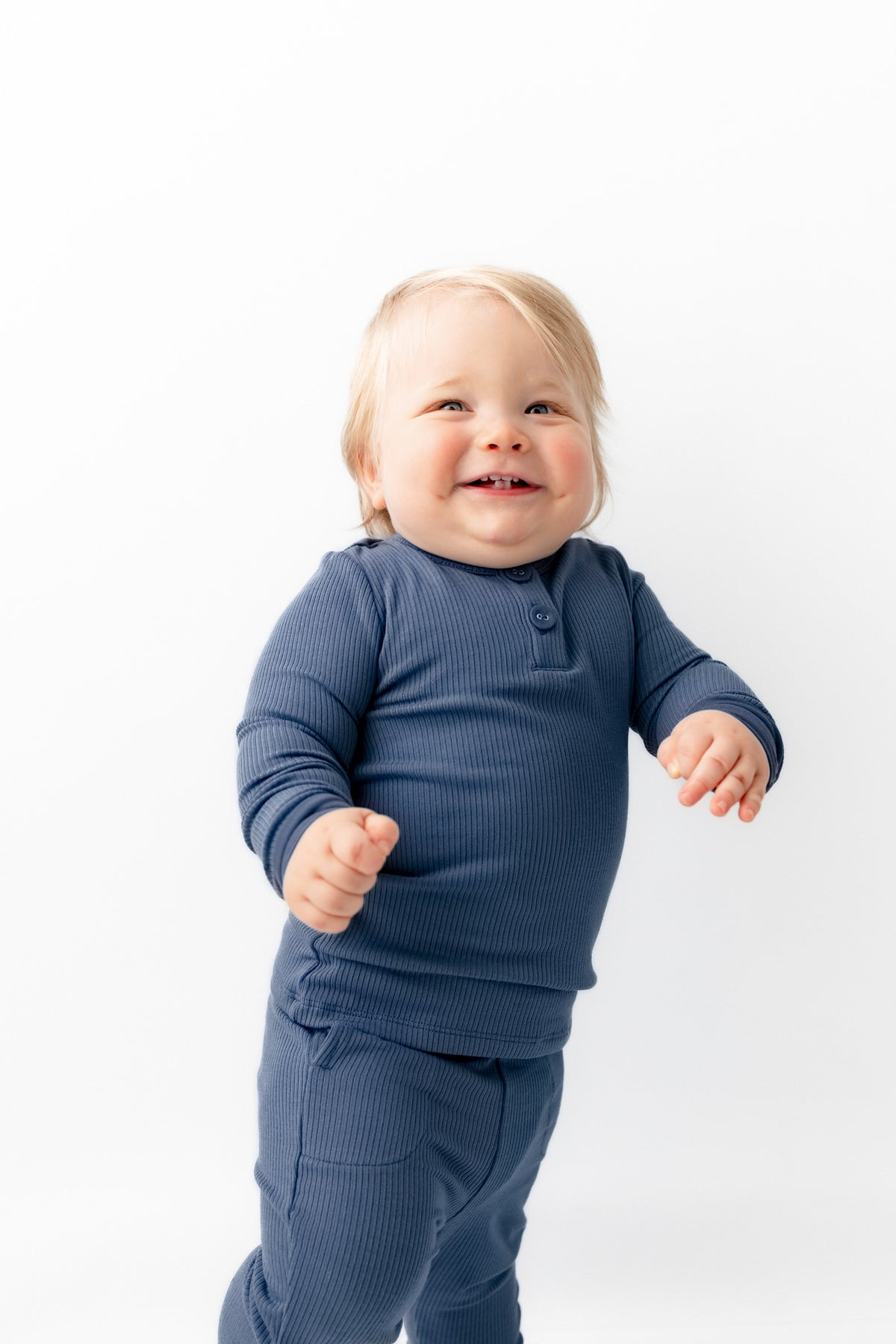 Baby smiling in Ribbed Infant Henley Set in Oxford on a white background