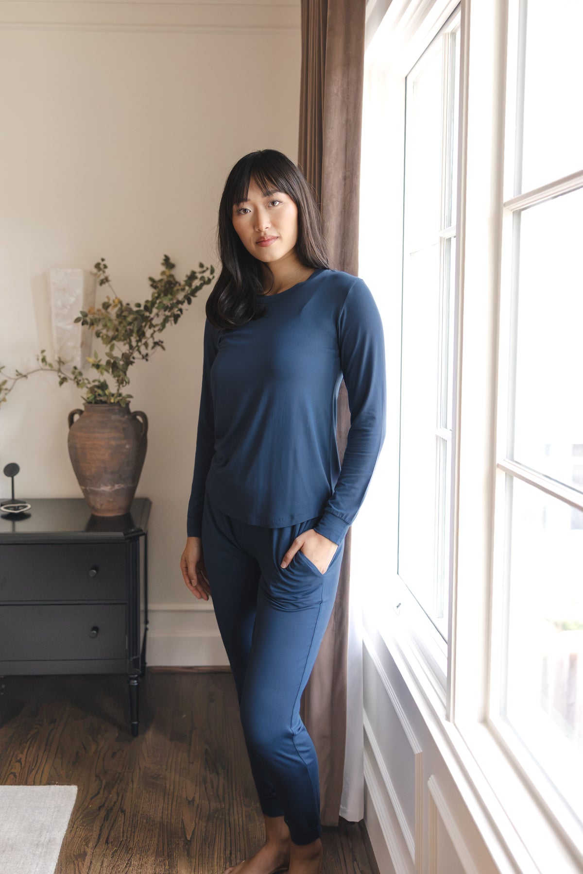 Modal wearing Women's Jogger Pajama Set in Oxford standing near a glass window