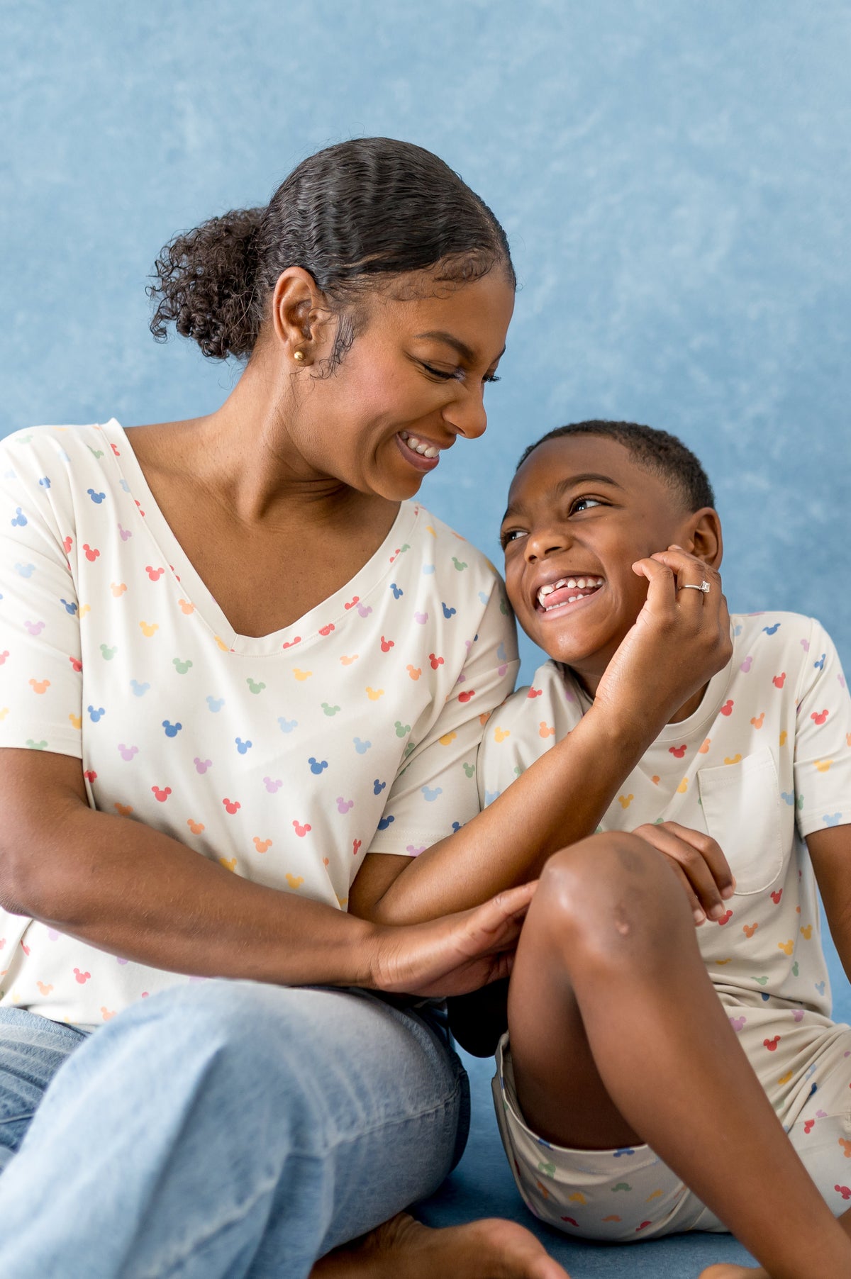 Mom and child wearing matching mickey ear patterned tshirts