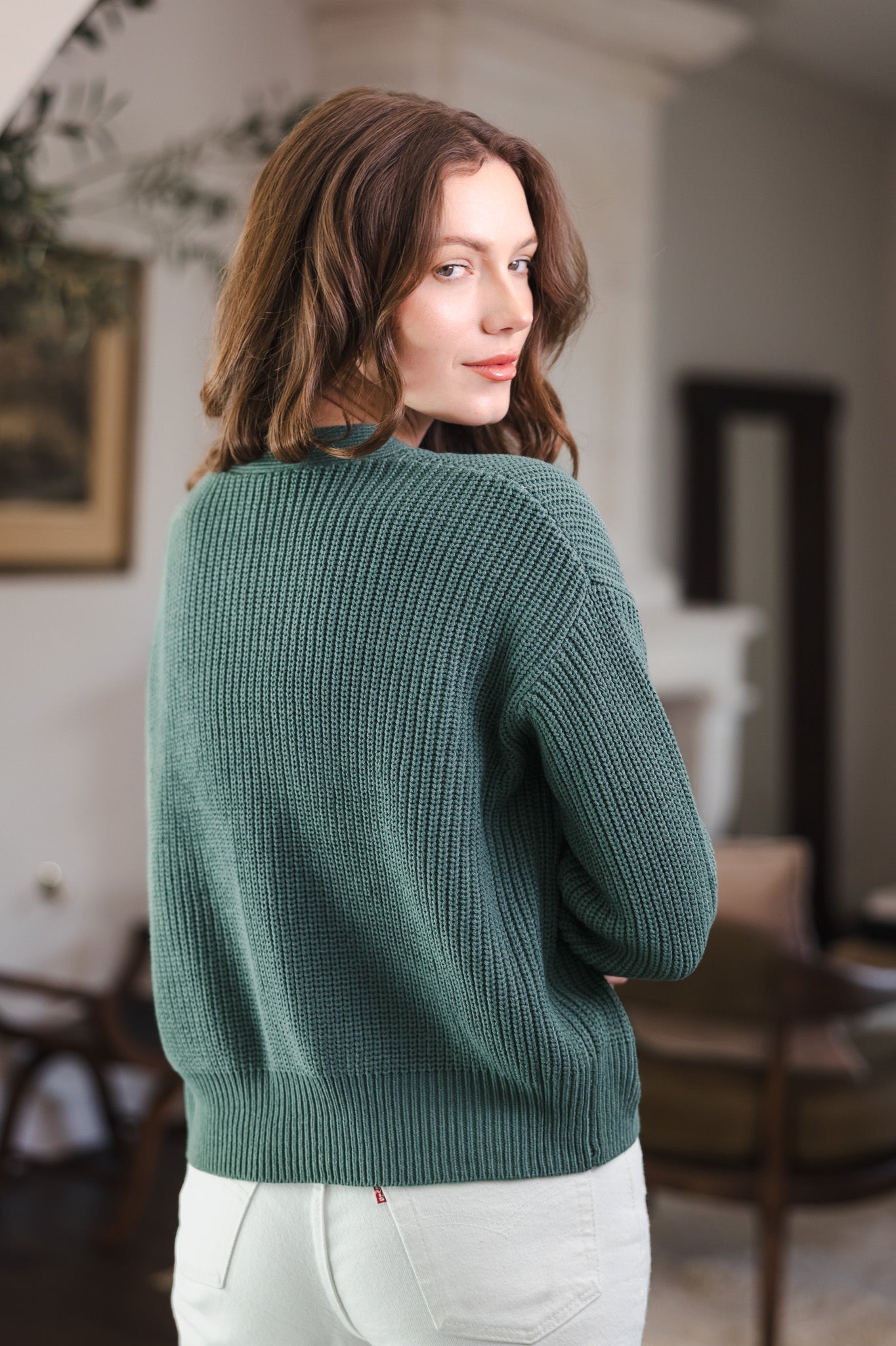 Modal showcasing the back side of Chunky Knit Women's Cropped Cardigan in Pine over white pants