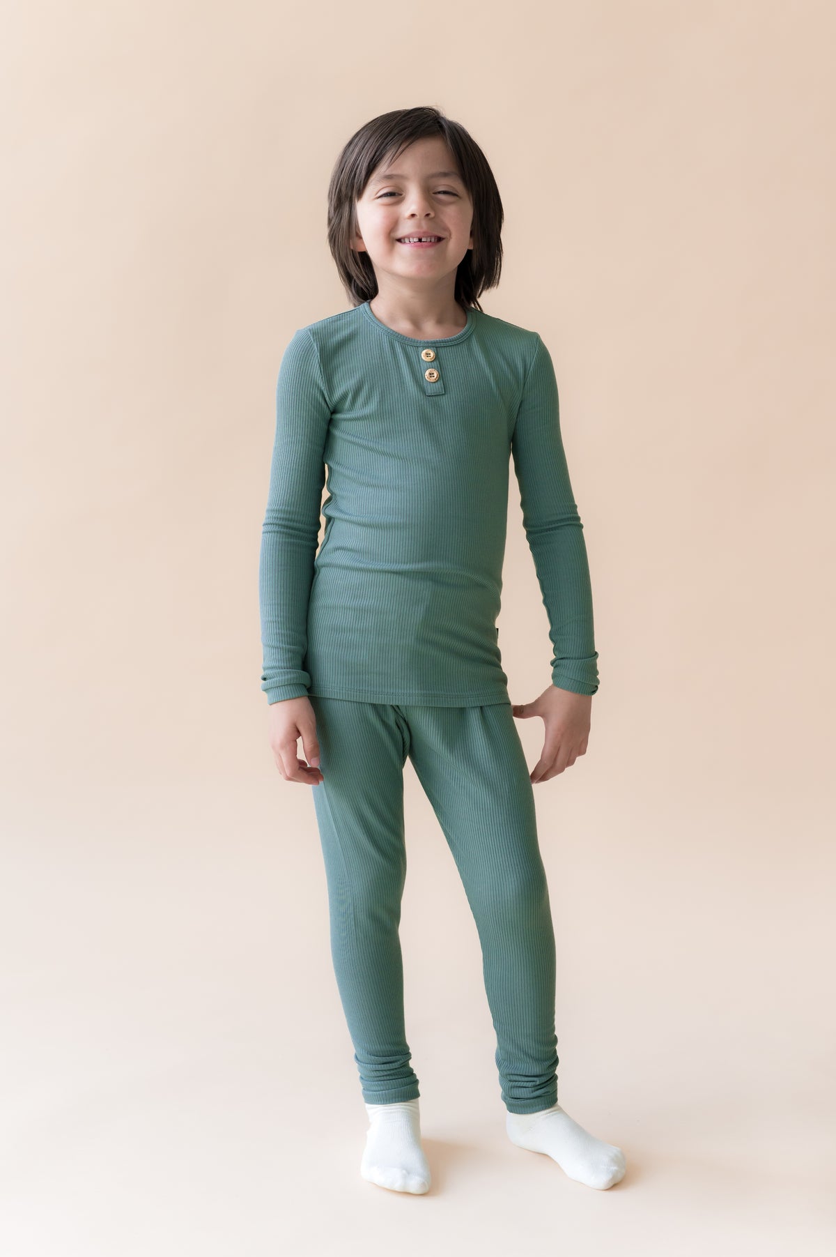 Boy wearing Ribbed Henley Set in Pine on a beige background