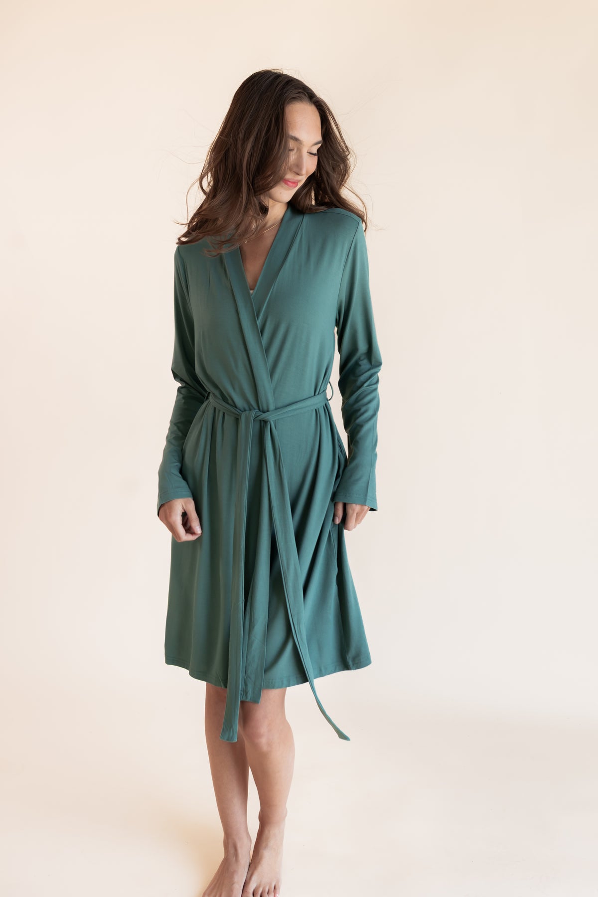 Model wearing Women's Lounge Robe in Pine on a beige background