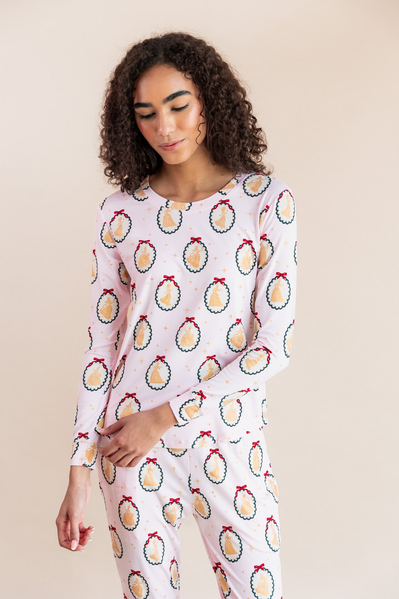 Woman wearing Women's Jogger Pajama Set in Princess Holiday Portraits print on a beige background