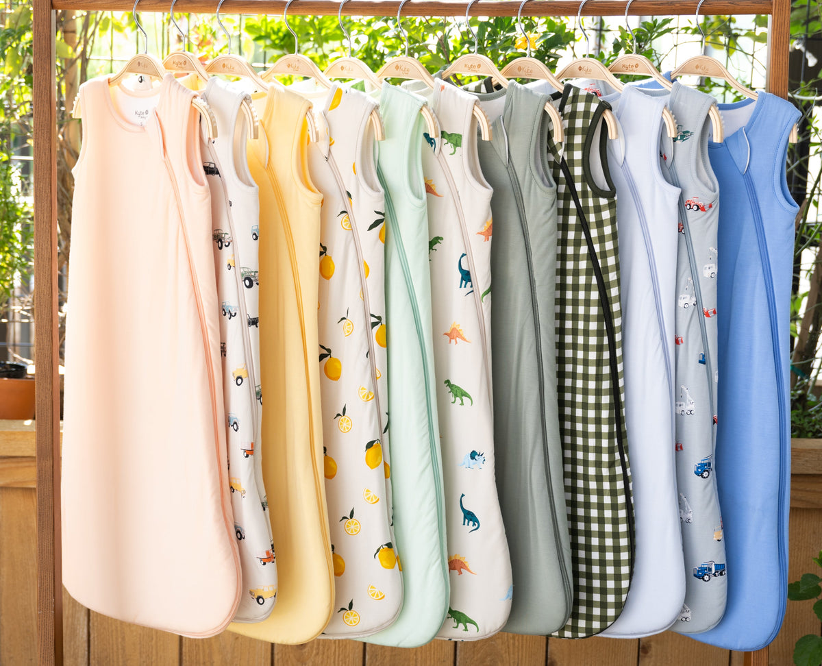 clothing rack with a colorful assortment of kyte baby sleep bags