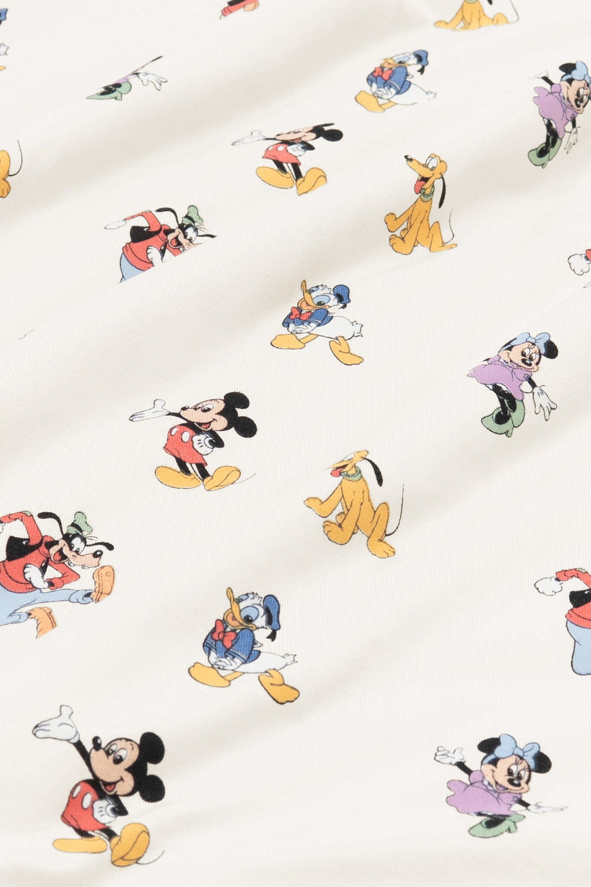 Fabric with mickey mouse and friends print on an oat background
