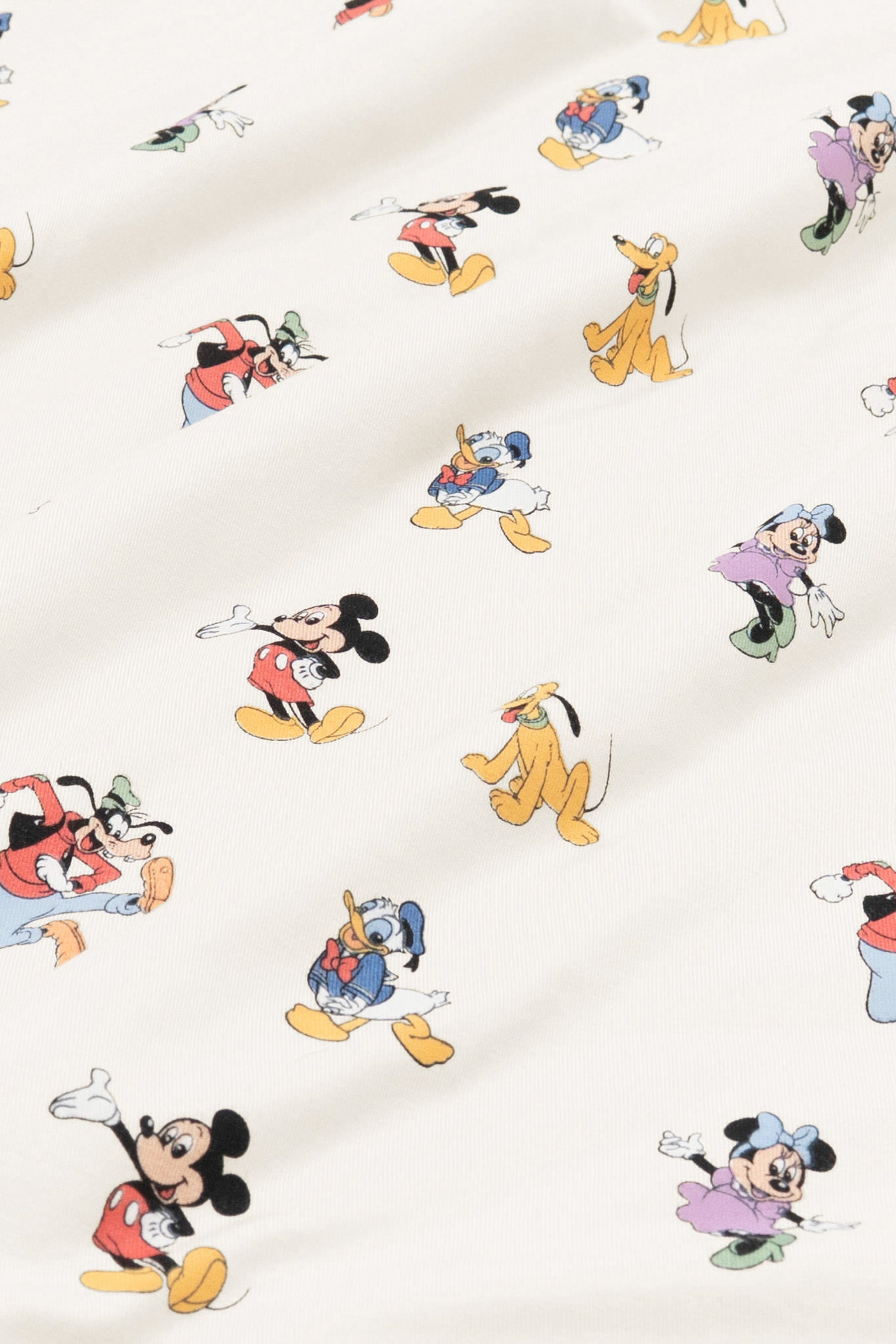 Fabric with mickey mouse and friends print on an oat background