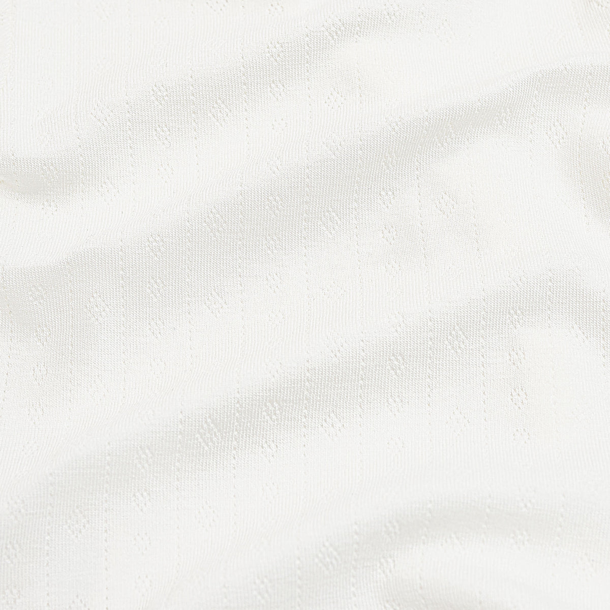 Close up of the white pointelle fabric
