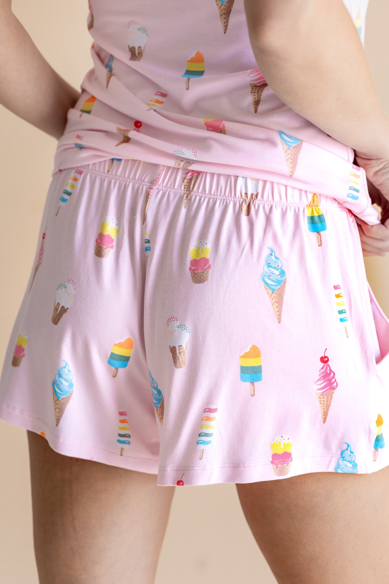 Model showcasing the back of Women's Tank Set shorts in Sakura Ice Cream print on beige background