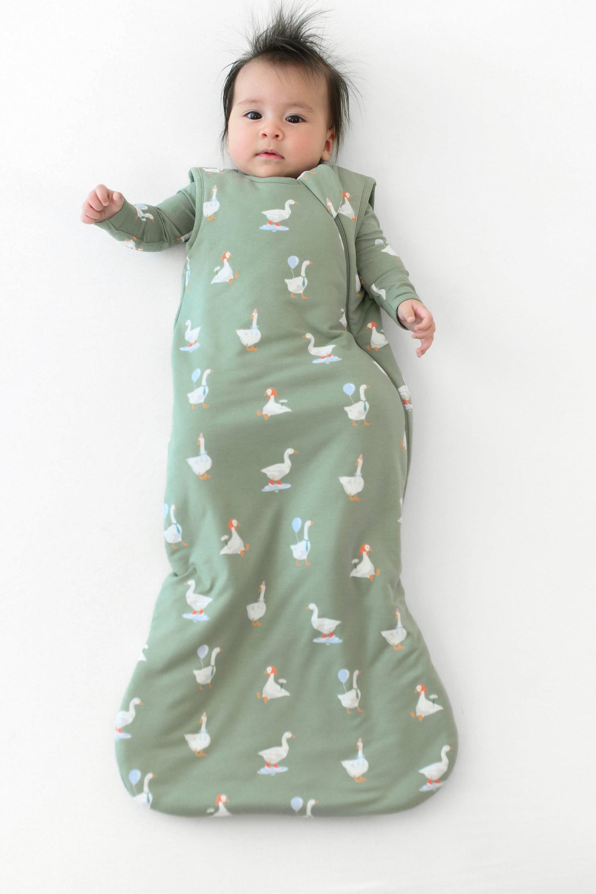 Infant wearing Sleep Bag in Silly Goose 1.0 with matching long sleeve romper