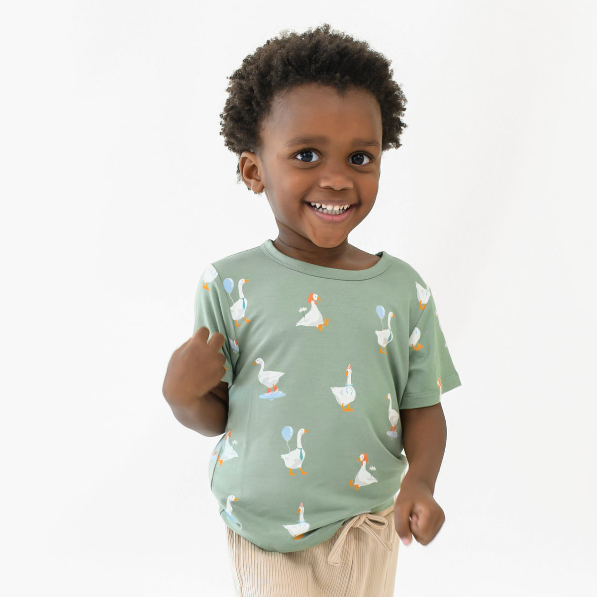 Close up of a young boy wearing the Toddler Basic Tee in Silly Goose 