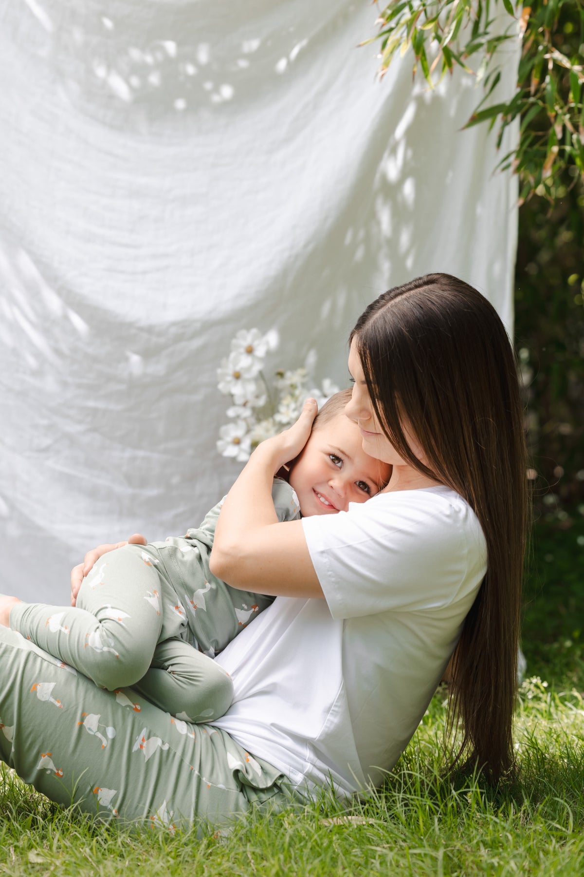 Mom and toddler snuggling wearing silly goose pajamas