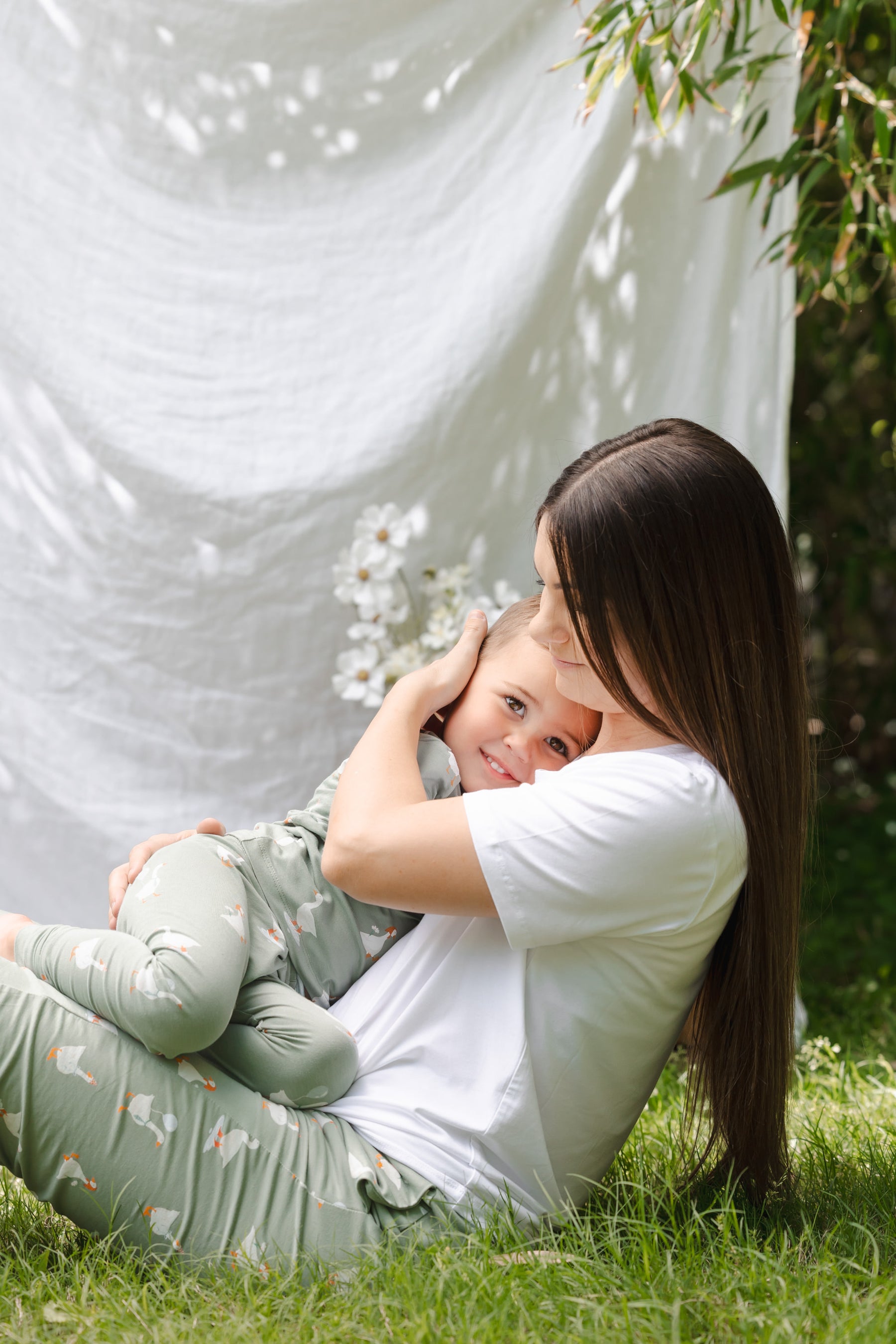 Mom and toddler snuggling wearing silly goose pajamas