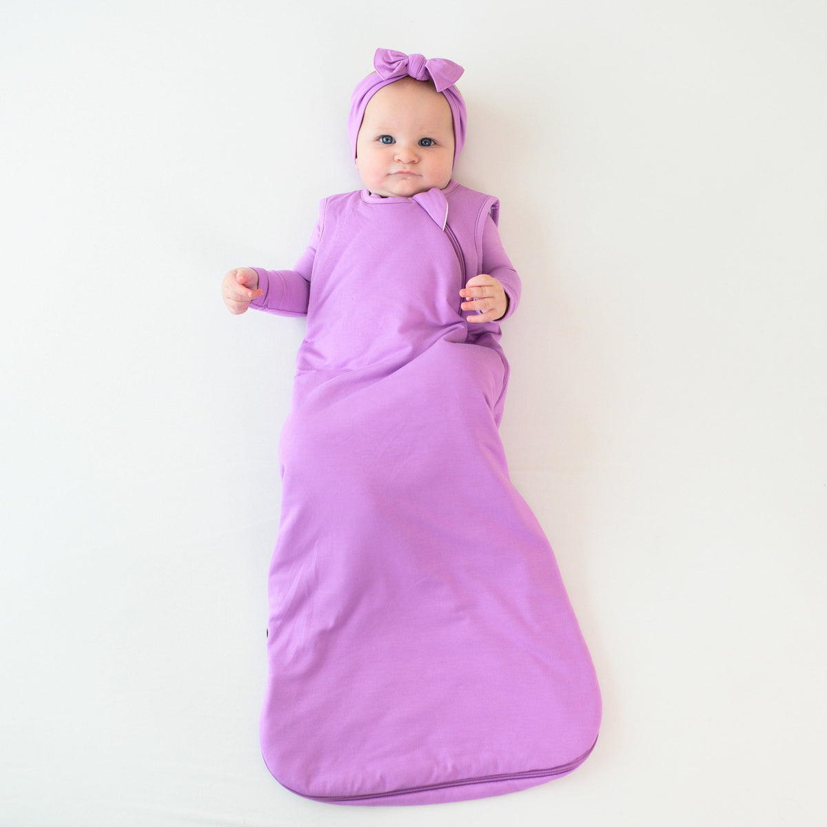 baby wearing kyte baby sleep bag 1.0 in poi with Poi Bow