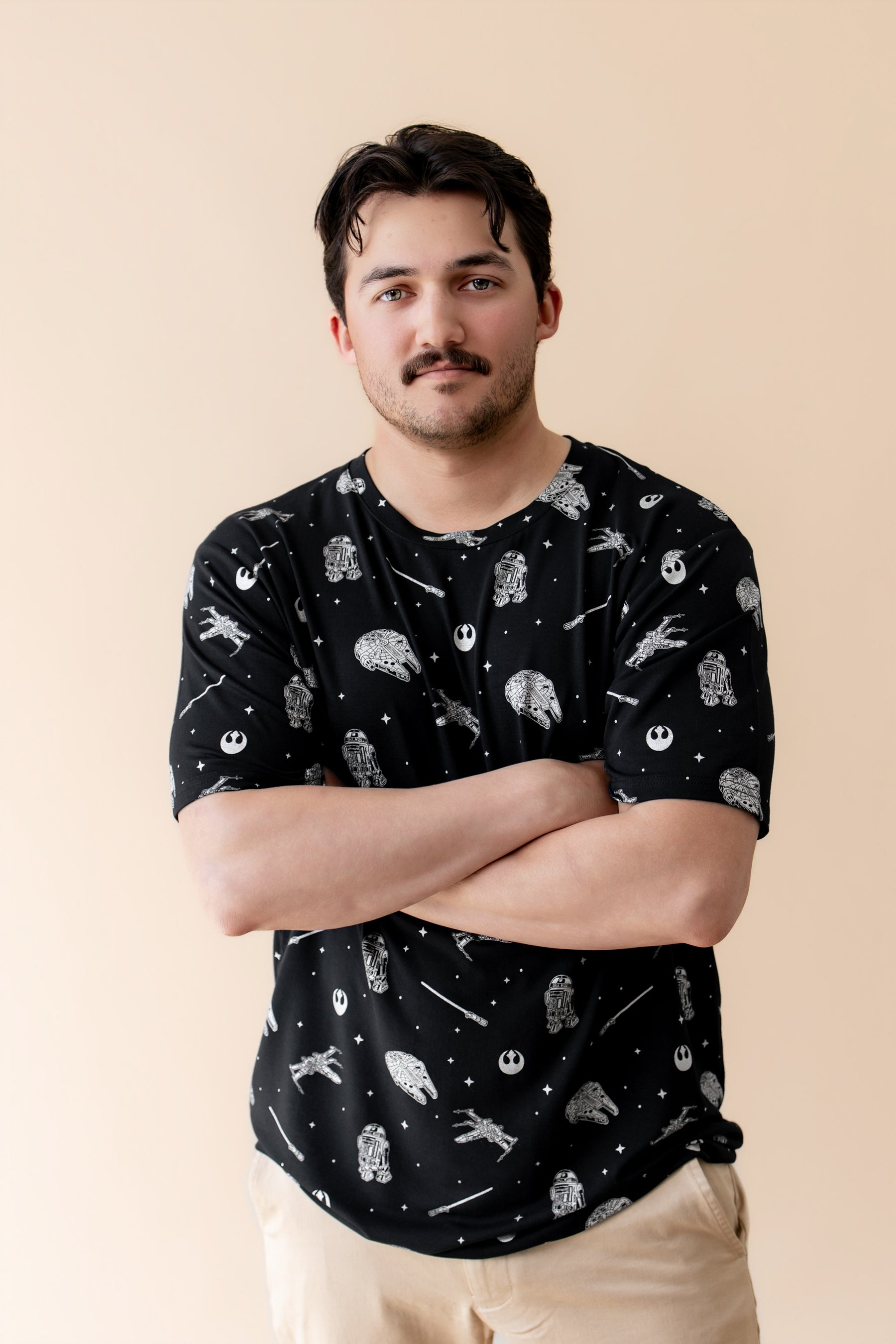Male modeling the Men's Crew Neck Tee in STAR WARS™ with his arms crossed in front of him