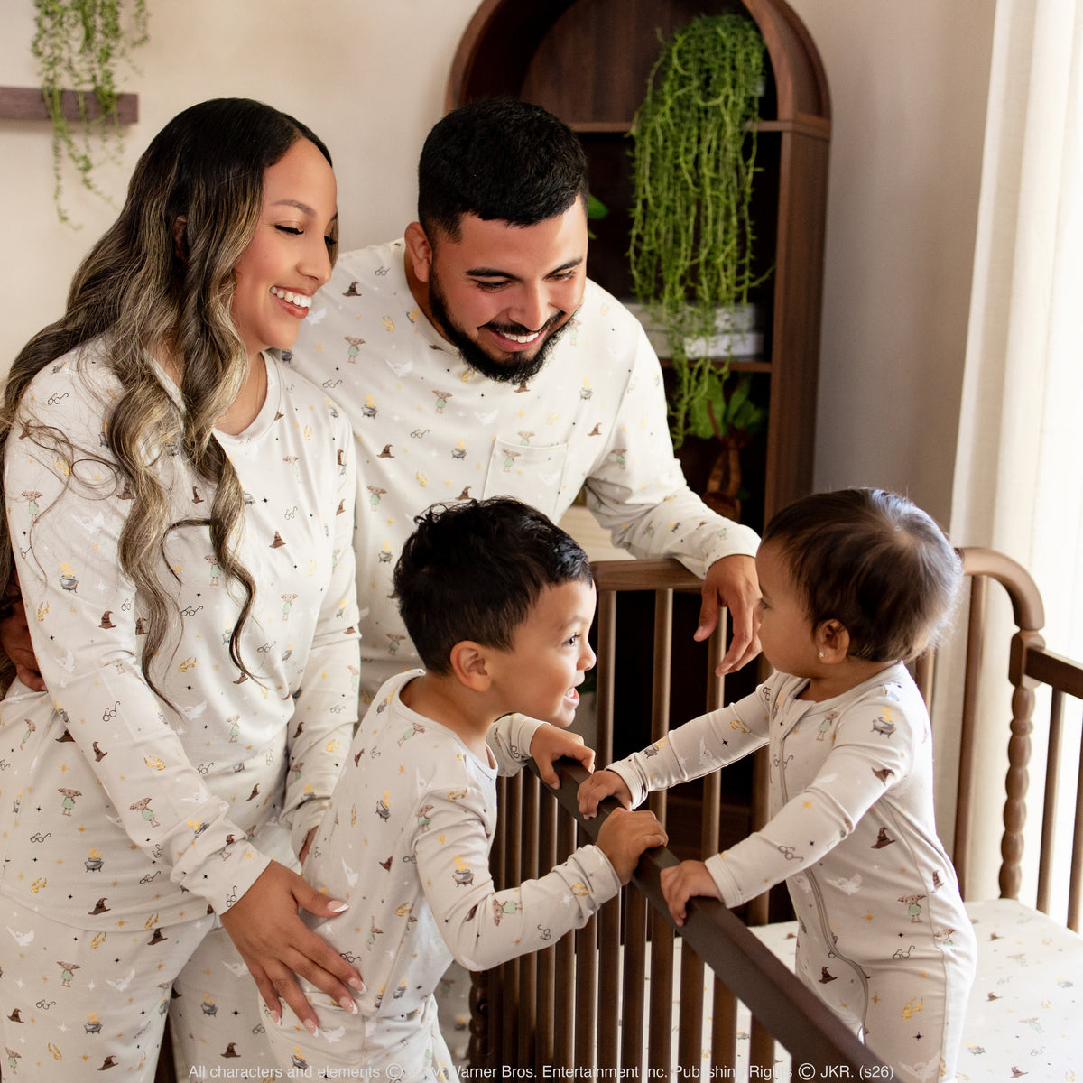 Family wearing Kyte Baby collaboration with Harry Potter in an inviting nursery setting