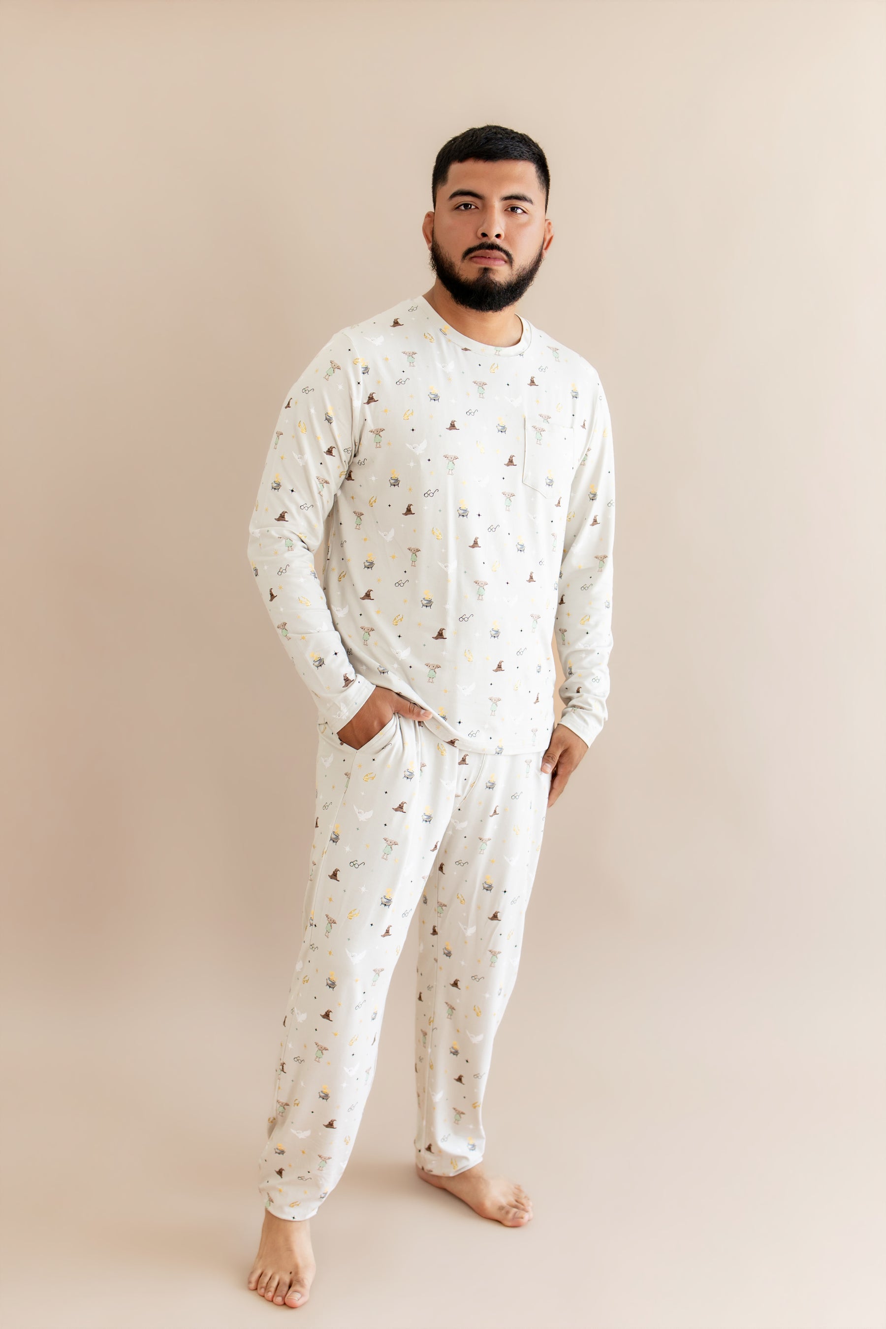 Person wearing a cream men's jogger set with Harry Potter prints on a beige background