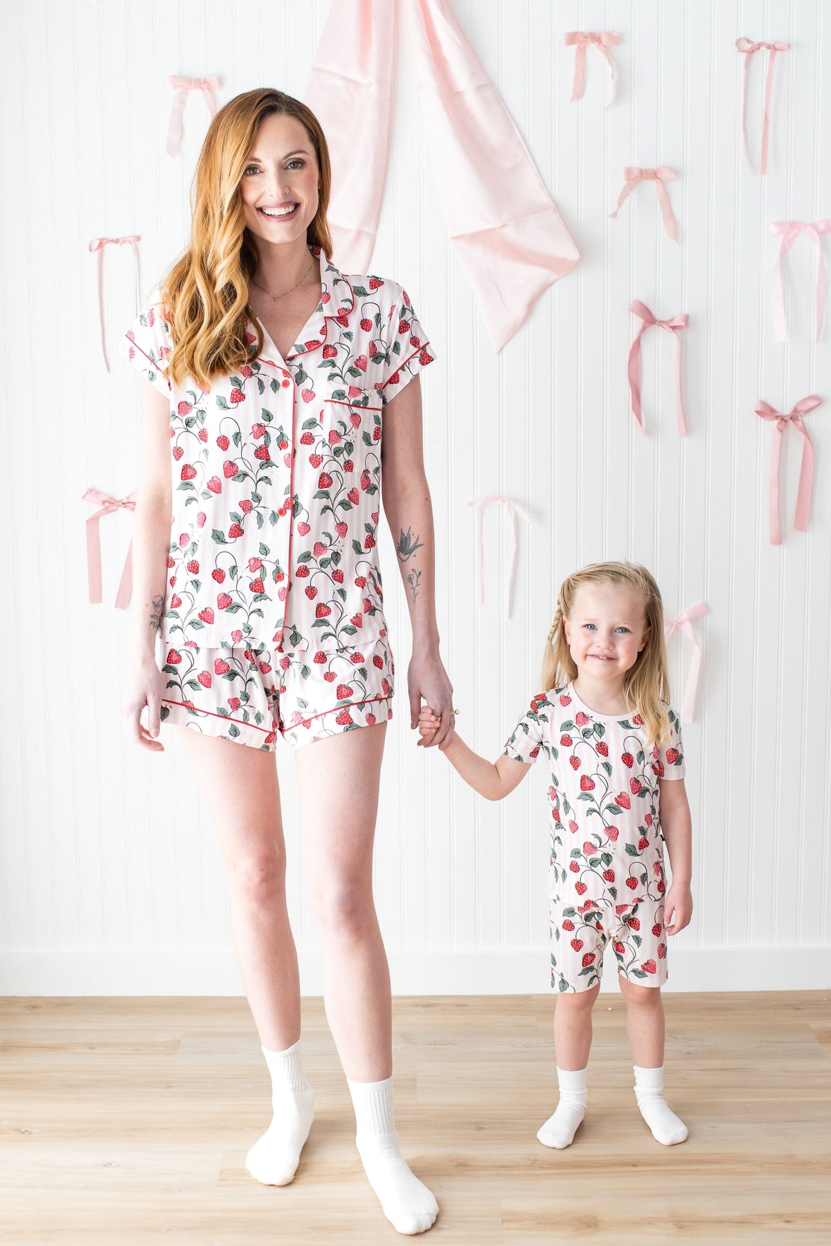 Mother and daughter holding hands wearing matching pajamas in  Strawberry Fields