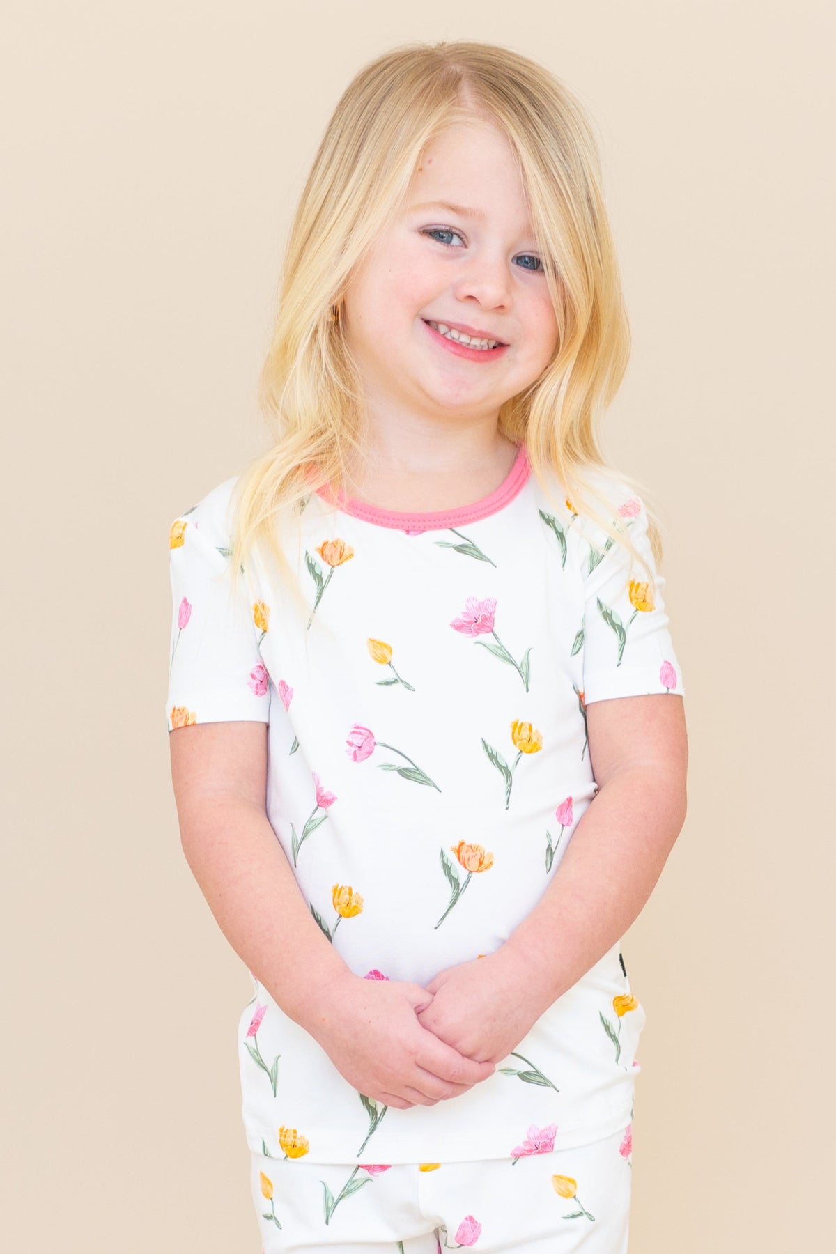 Close up of young model wearing the Short Sleeve Pajamas in Tulip