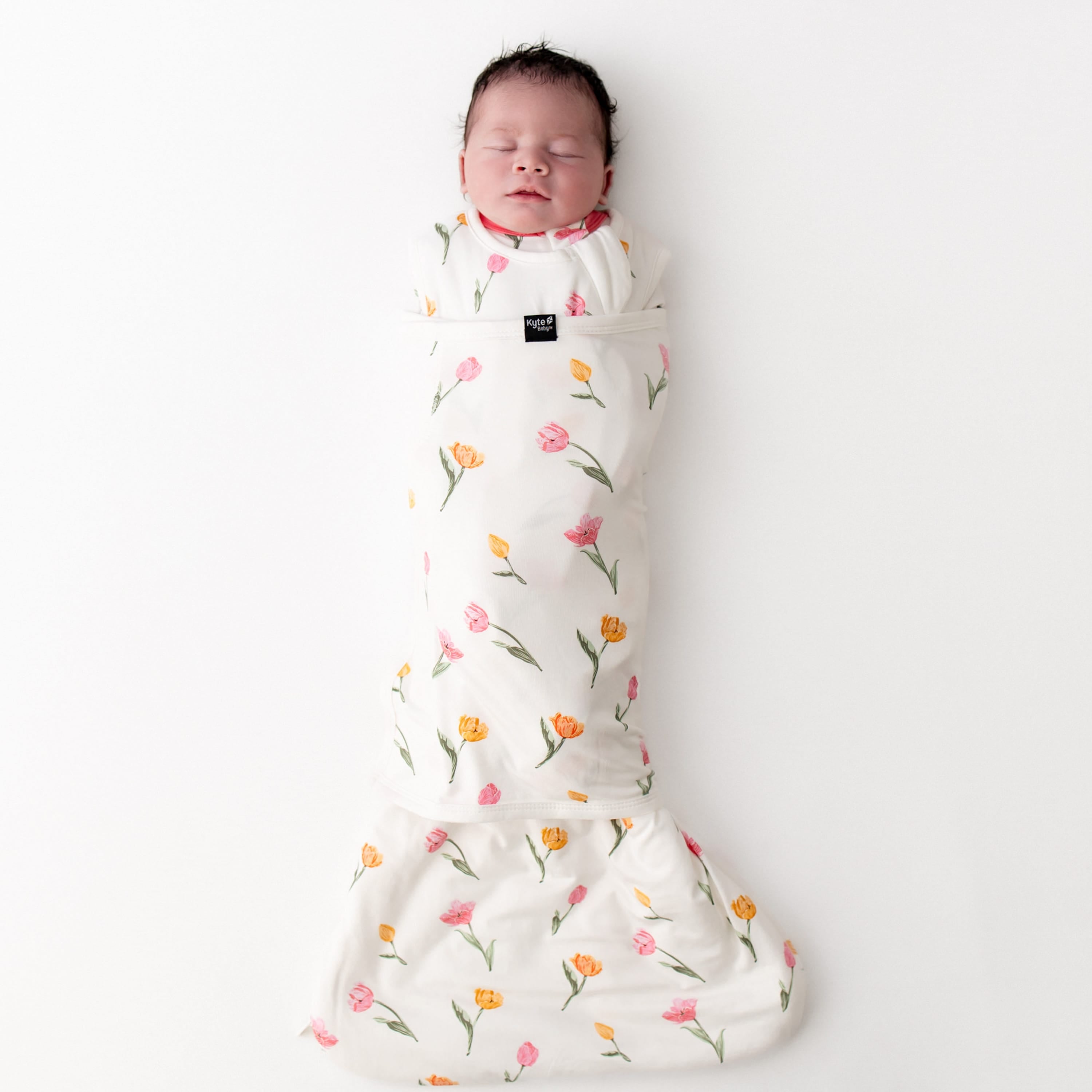 sleeping newborn swaddled in the Sleep Bag Swaddler in Tulip 1.0