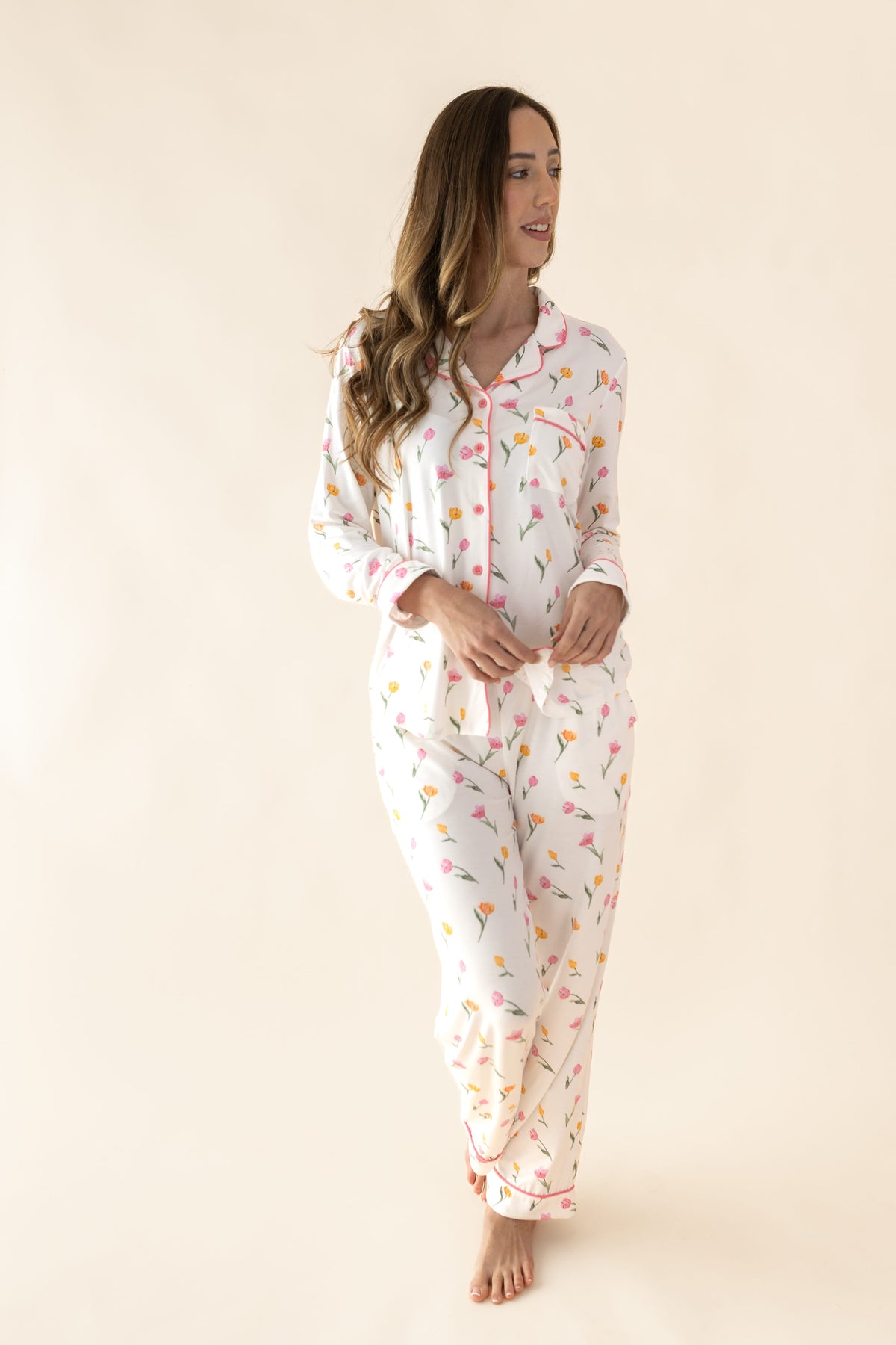 Female standing in front of a light taupe background wearing the Long Sleeve Women’s Nightshirt in Tulip
