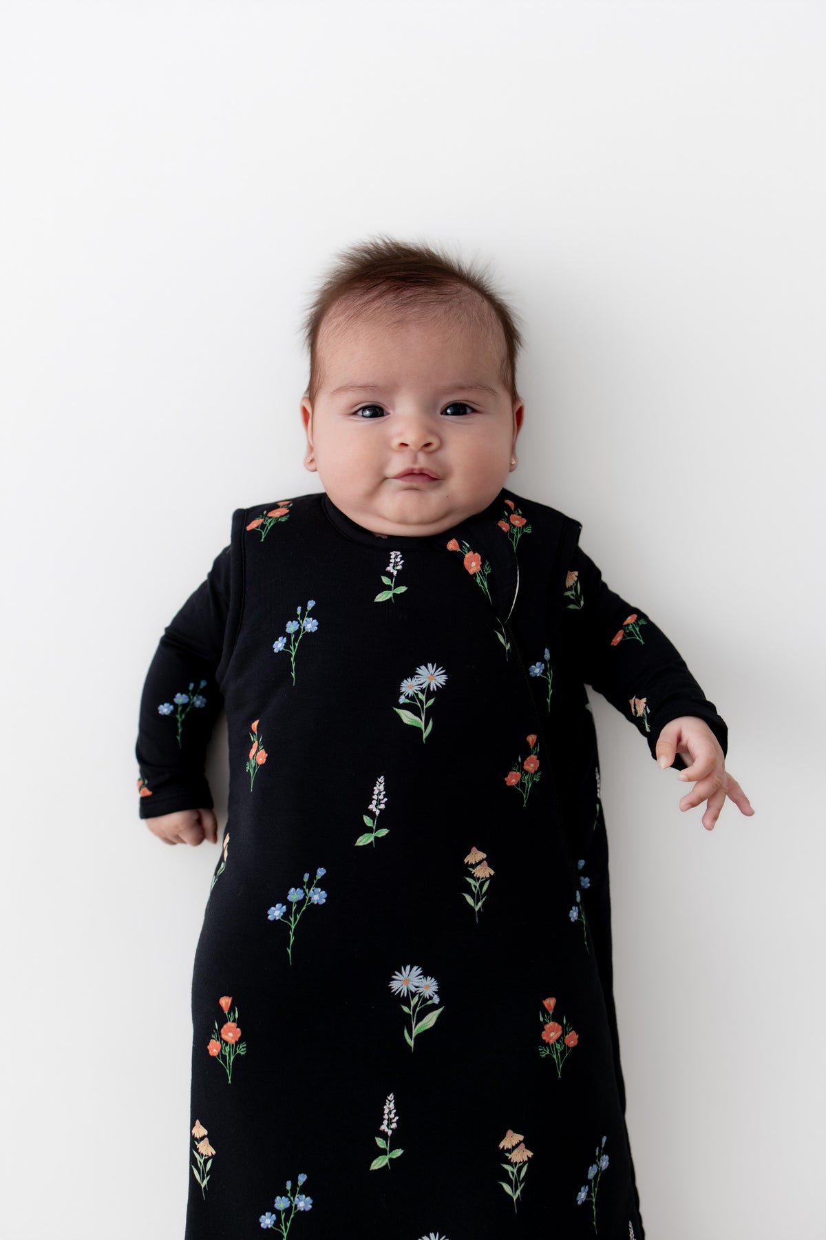 Baby in Sleep Bag with Midnight Wildflower 2.5 print on a white background