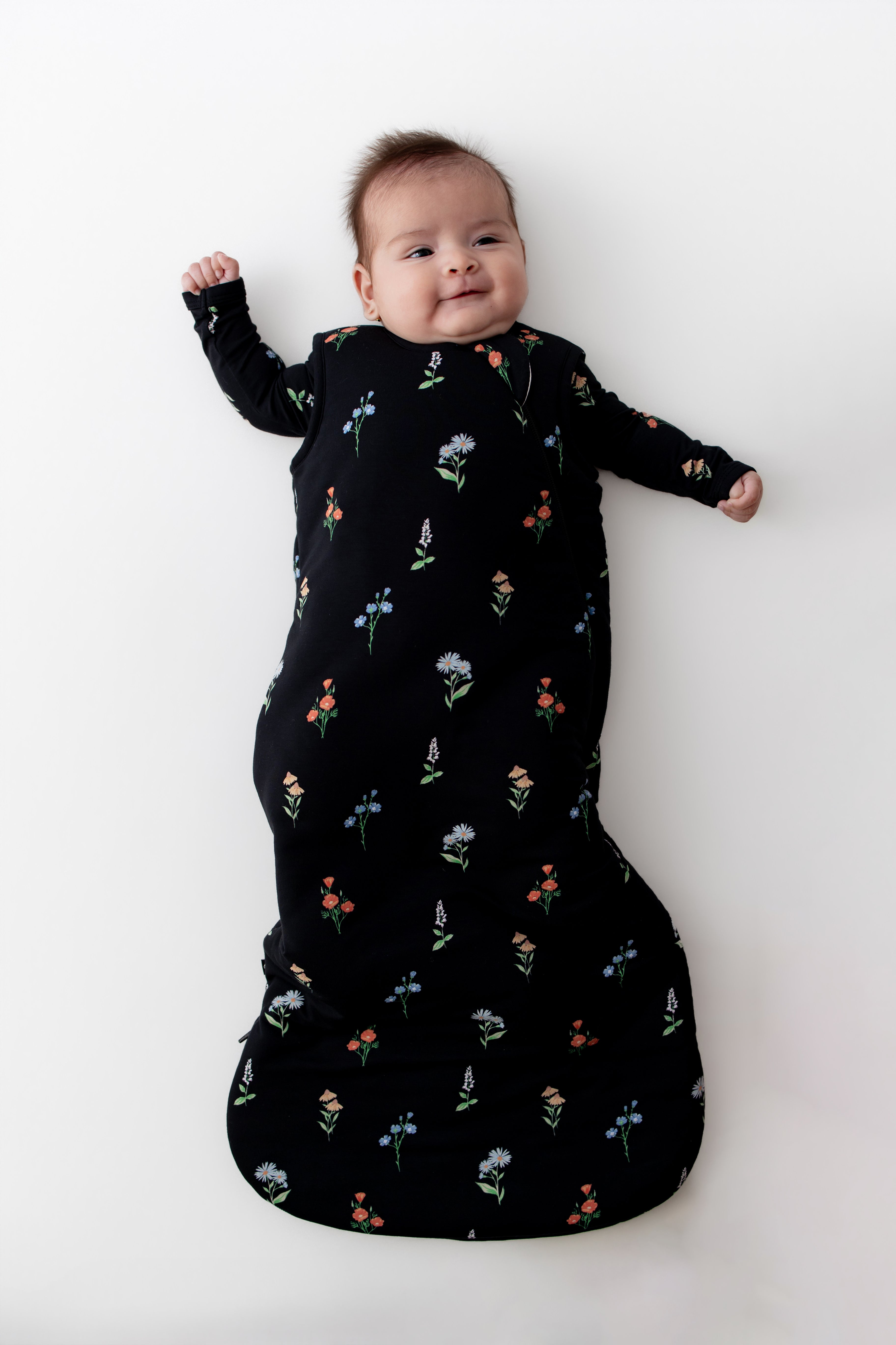 Baby in Sleep Bag with Midnight Wildflower 2.5 print on a white background