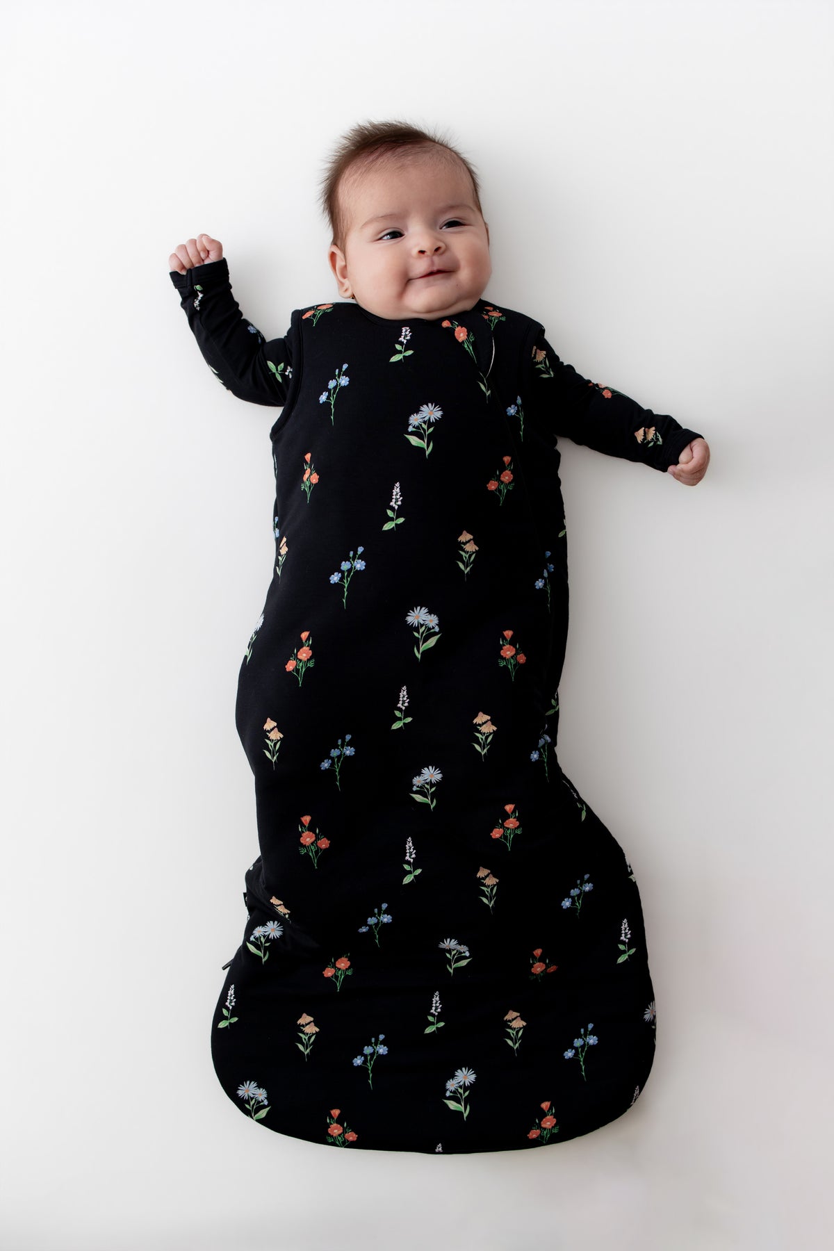 Baby in Sleep Bag with Midnight Wildflower 2.5 print on a white background