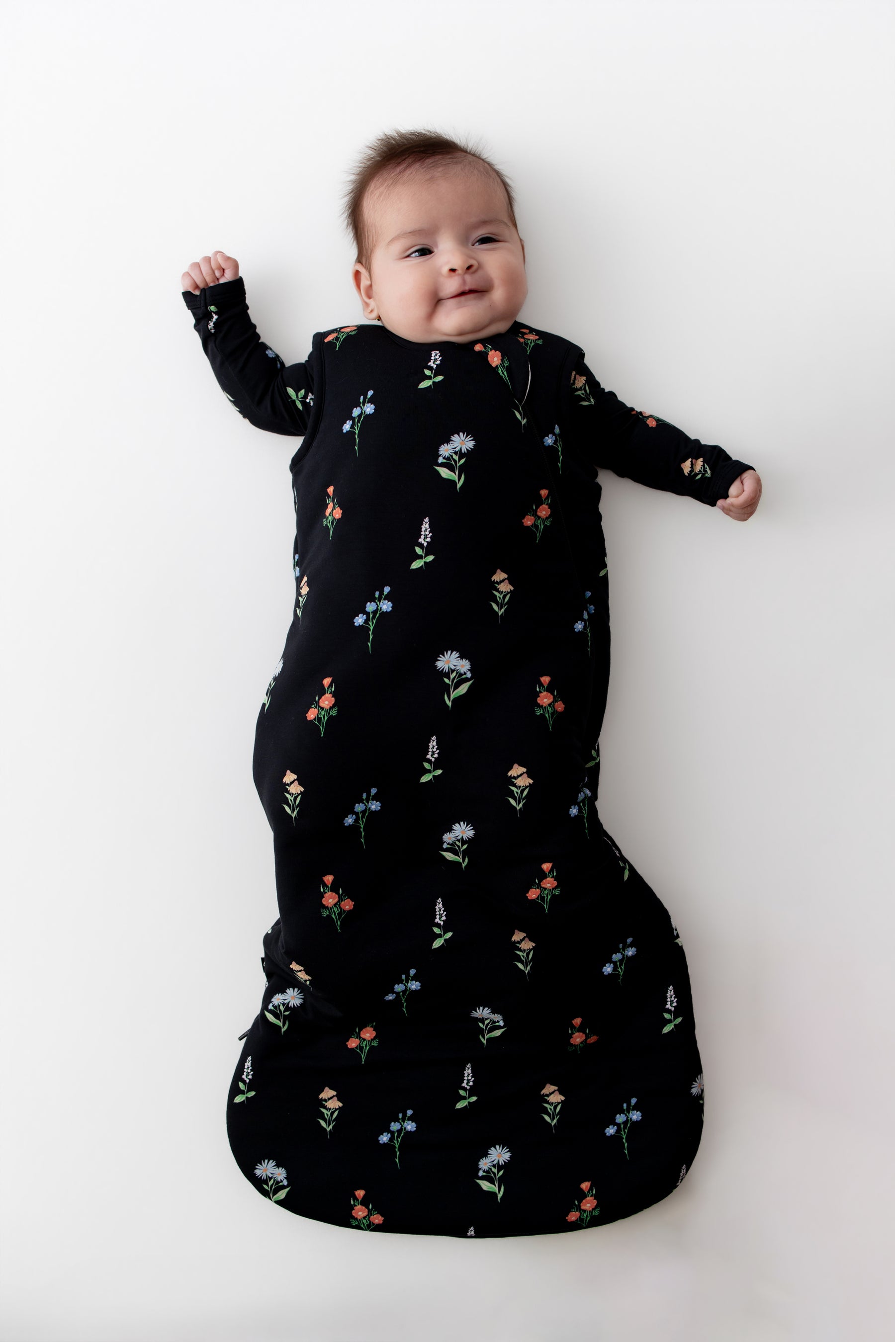 Baby in Sleep Bag with Midnight Wildflower 2.5 print on a white background
