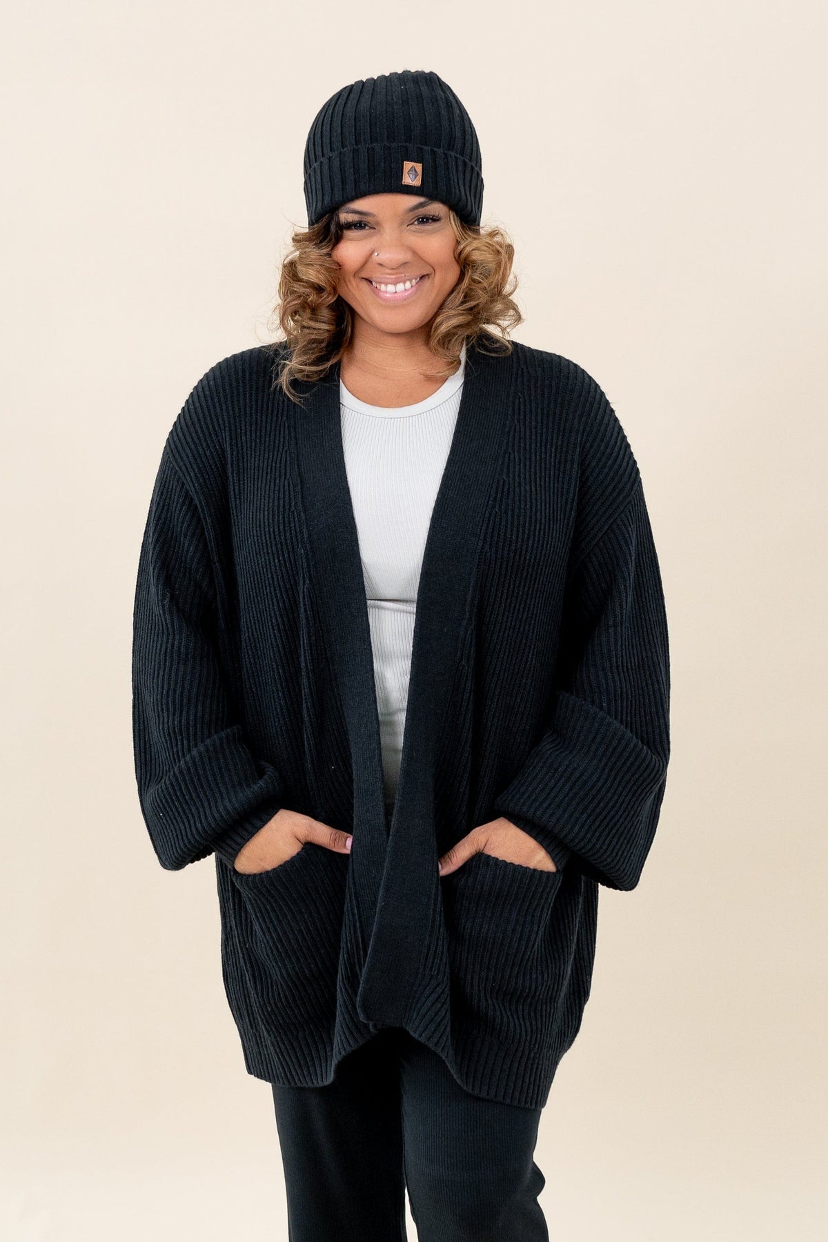 Woman wearing Kyte Baby Chunky Knit Women's Oversized Cardigan in Midnight