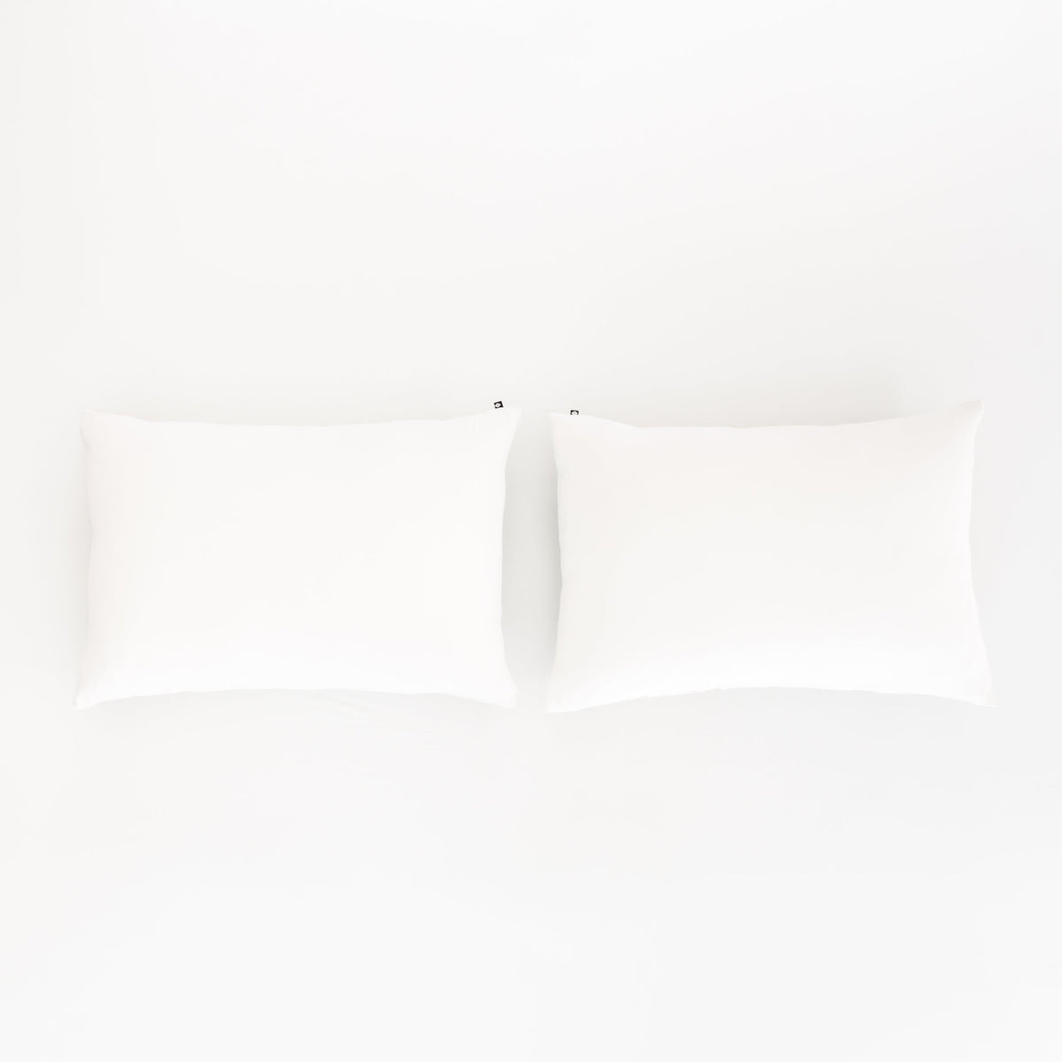 Bed Made with Kyte Baby Fitted Sheet with Pillowcases in Cloud