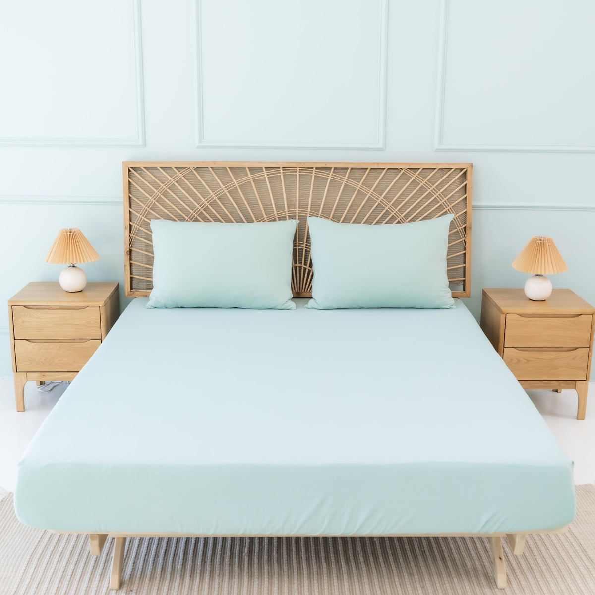 Bed Made with Kyte Baby Fitted Sheet with Pillowcases in Sage green