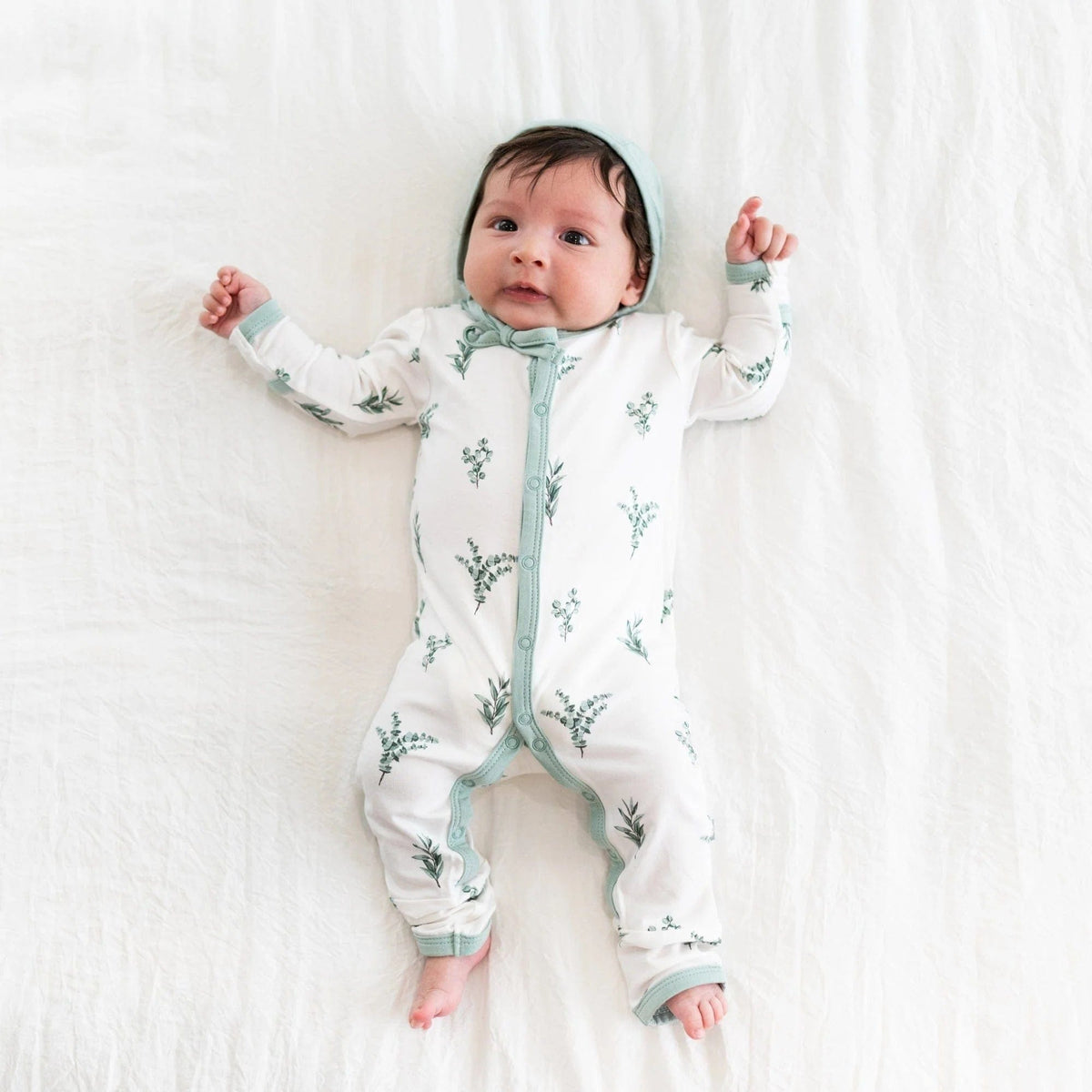 Newborn wearing  Bonnet in Sage and a Romper in Eucalyptus