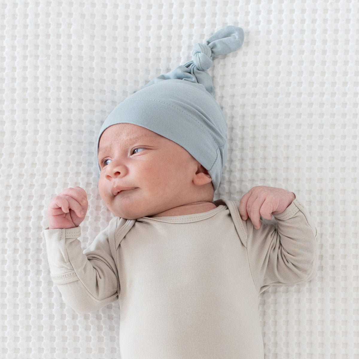 Infant wearing bamboo Kyte Baby Knotted Cap in Fog