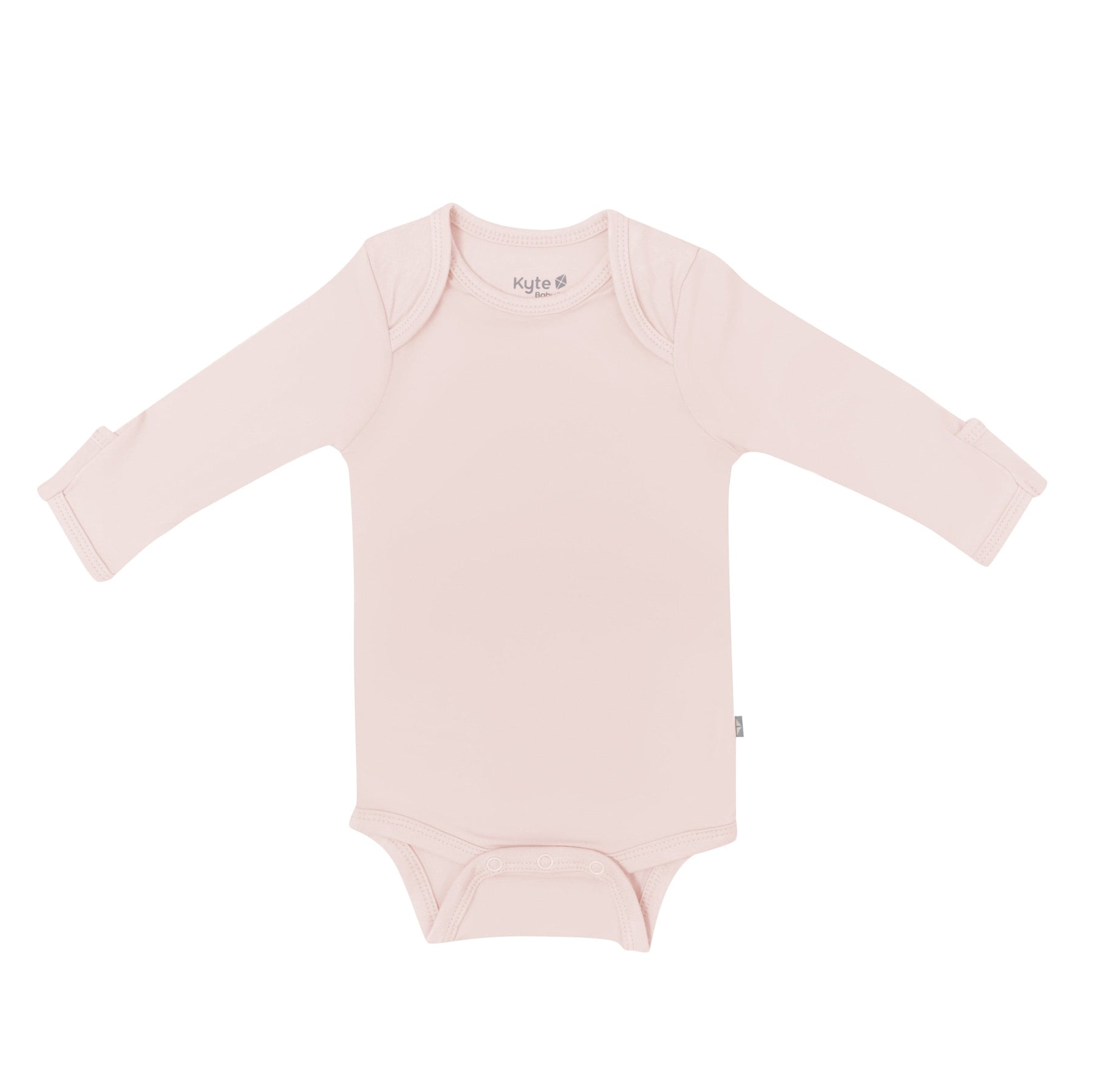 Flat lay of Kyte Baby Long Sleeve Bodysuit in  Blush
