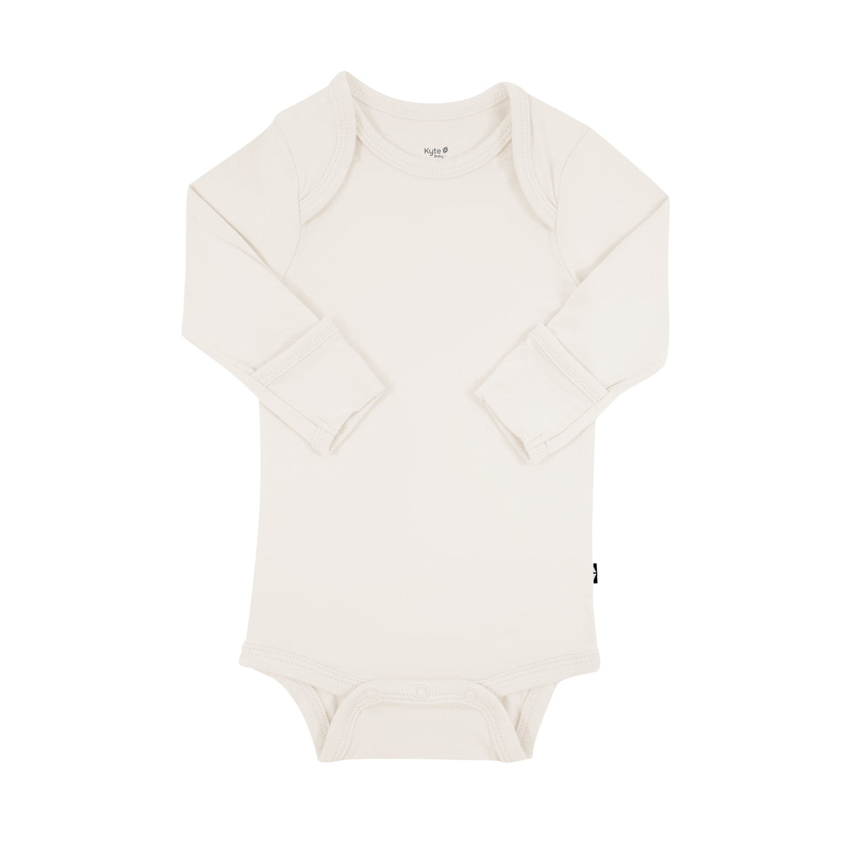 Flat lay of Kyte Baby Long Sleeve Bodysuit in Oat with arms folded inwards displaying fold-over cuffs