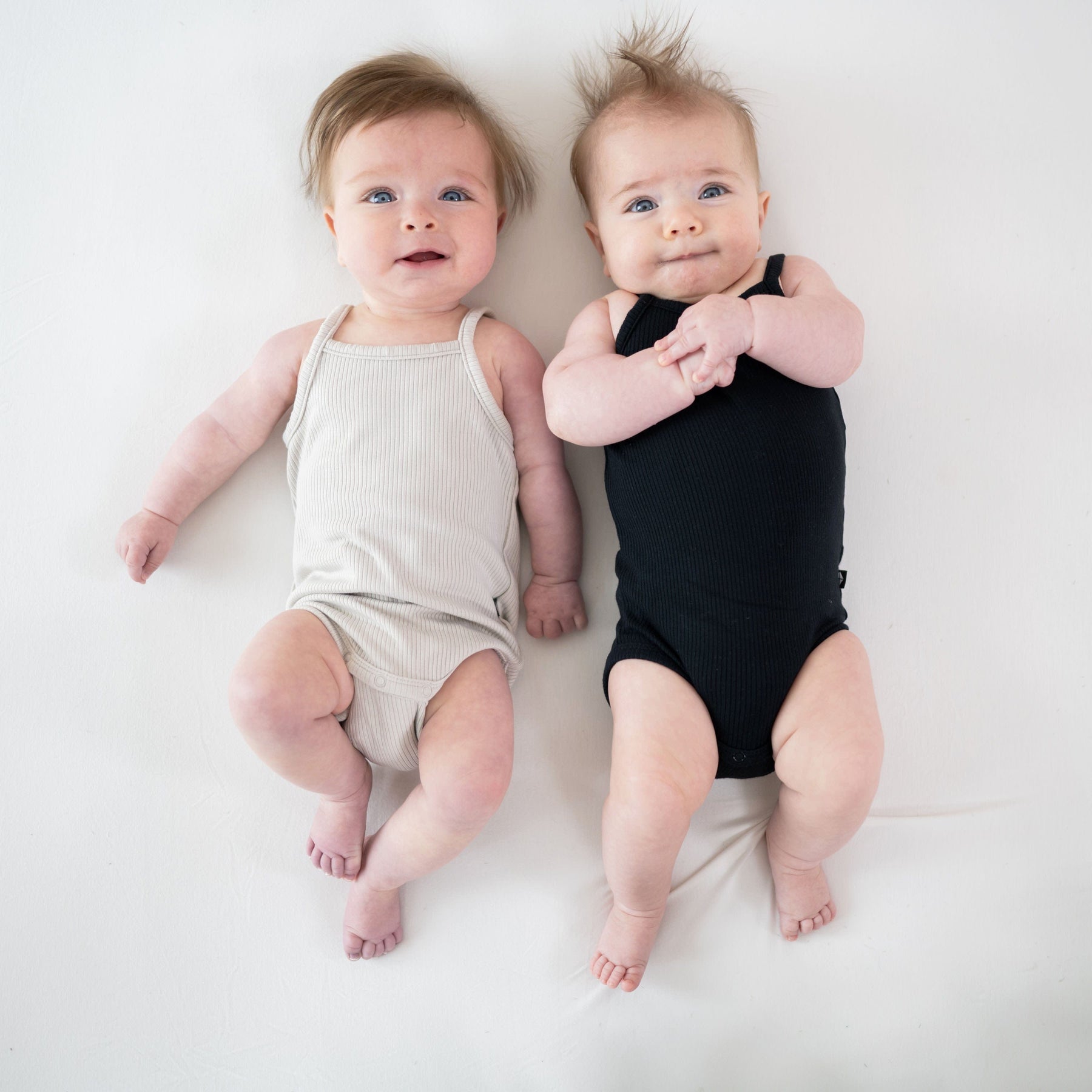 Babies wearing Kyte Baby Ribbed Spaghetti Strap Bodysuits