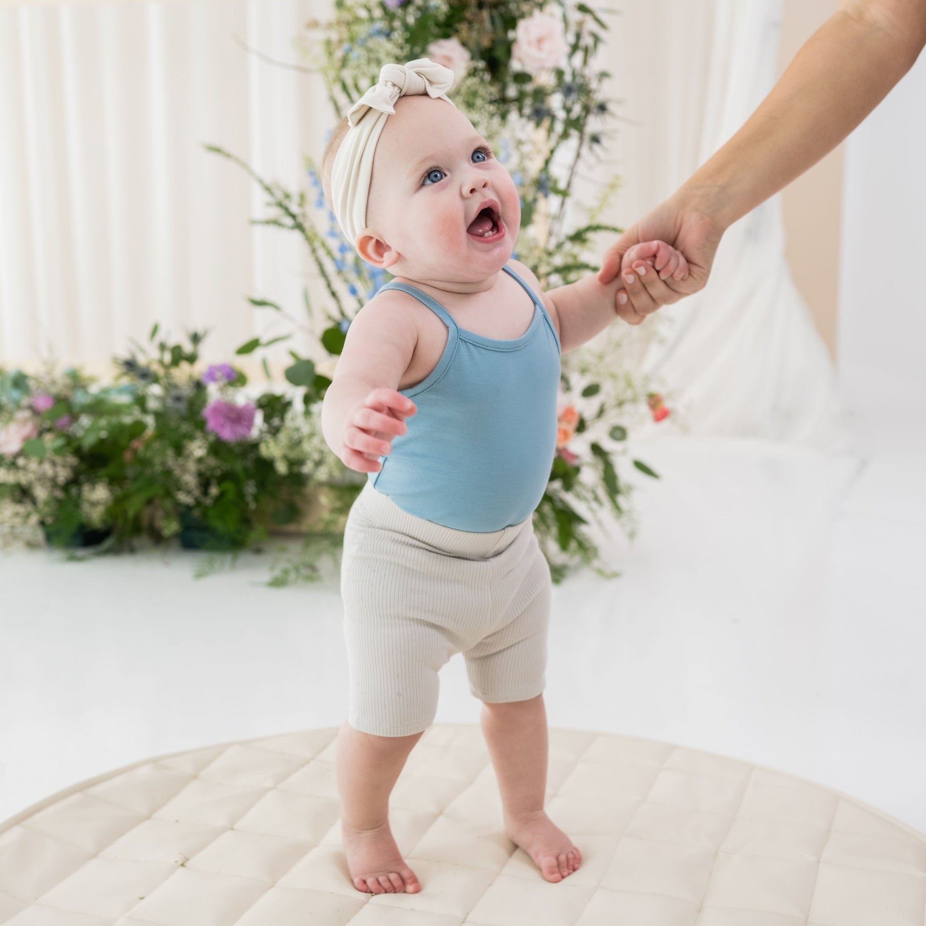 Girl wearing Kyte Baby Ribbed Toddler Bike Shorts in Oat