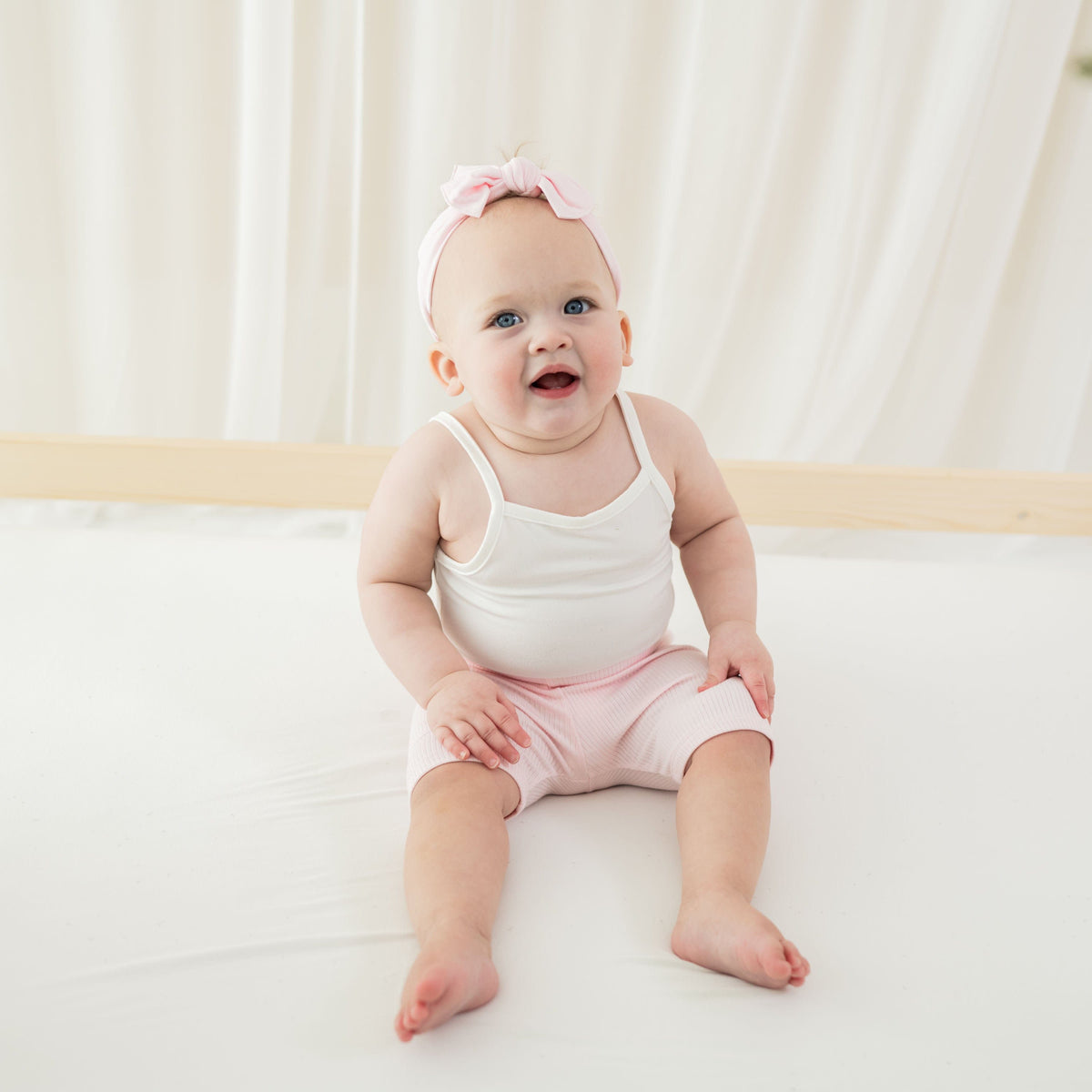 Girl wearing Kyte Baby Ribbed Toddler Bike Shorts in Sakura