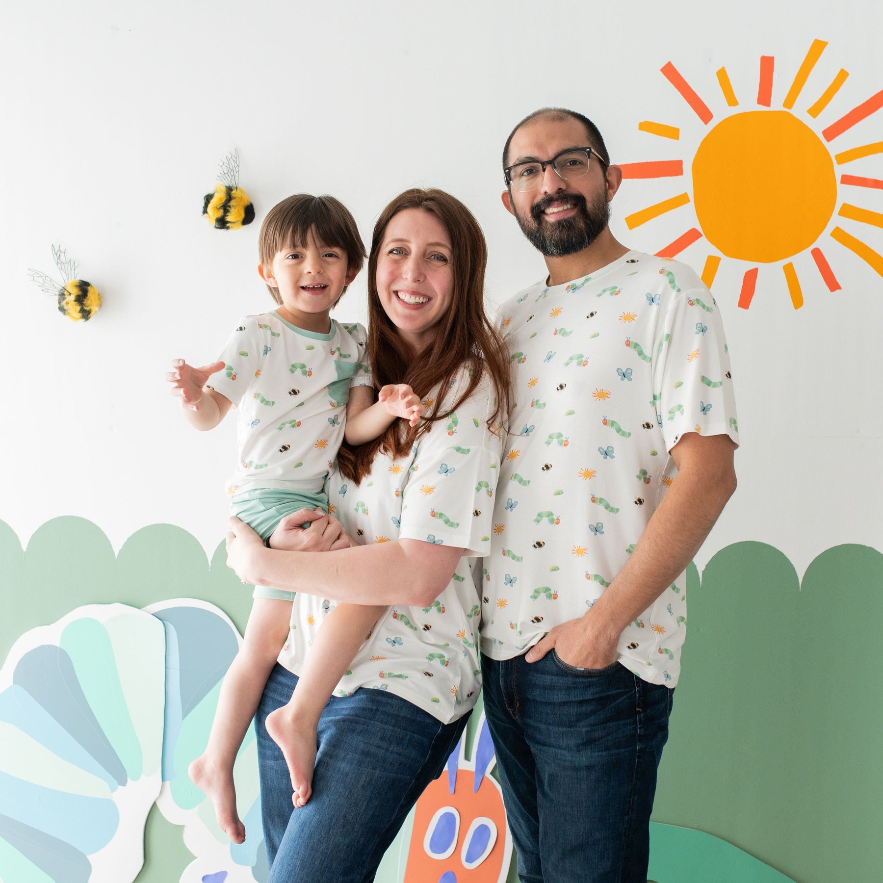 Family wearing matching Kyte Baby tees in The Very Hungry Caterpillar™ and Friends