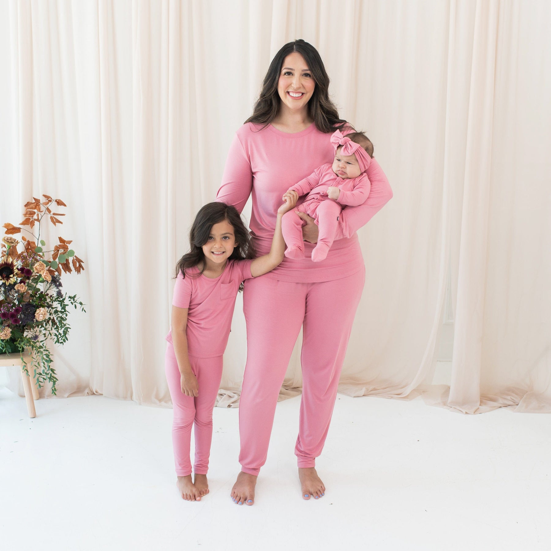 Mom and daughters wearing matching family pajamas in Apple Blossom