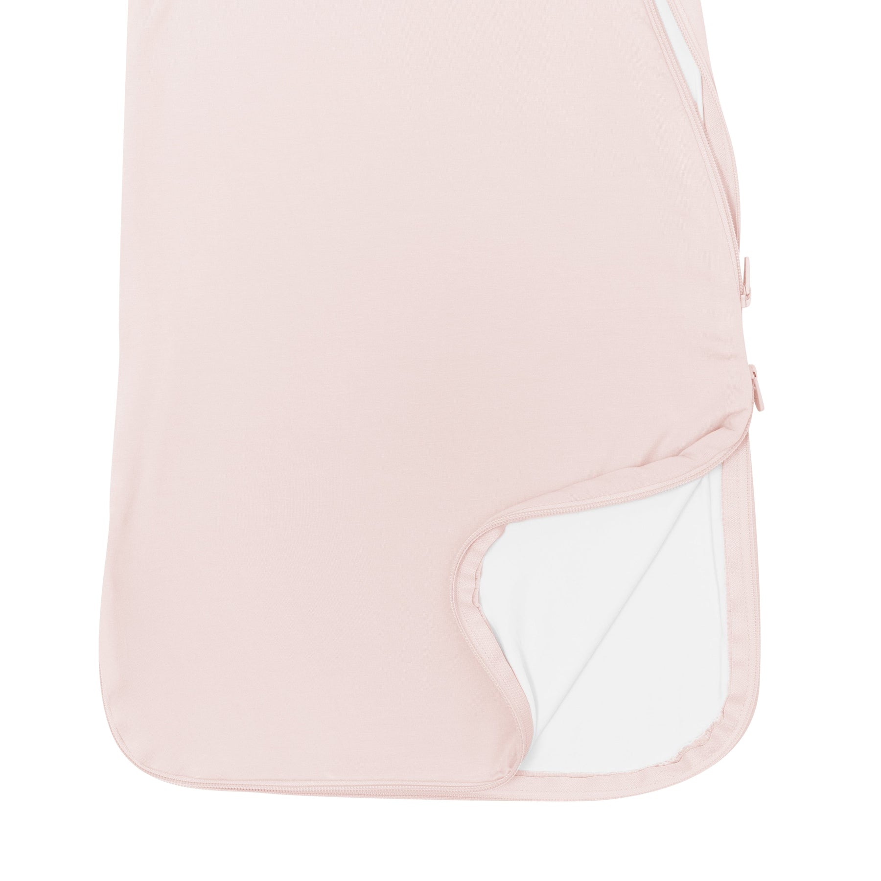 Close up of unzipped double zipper on Kyte Baby bamboo Sleep Bag in Blush 0.5 