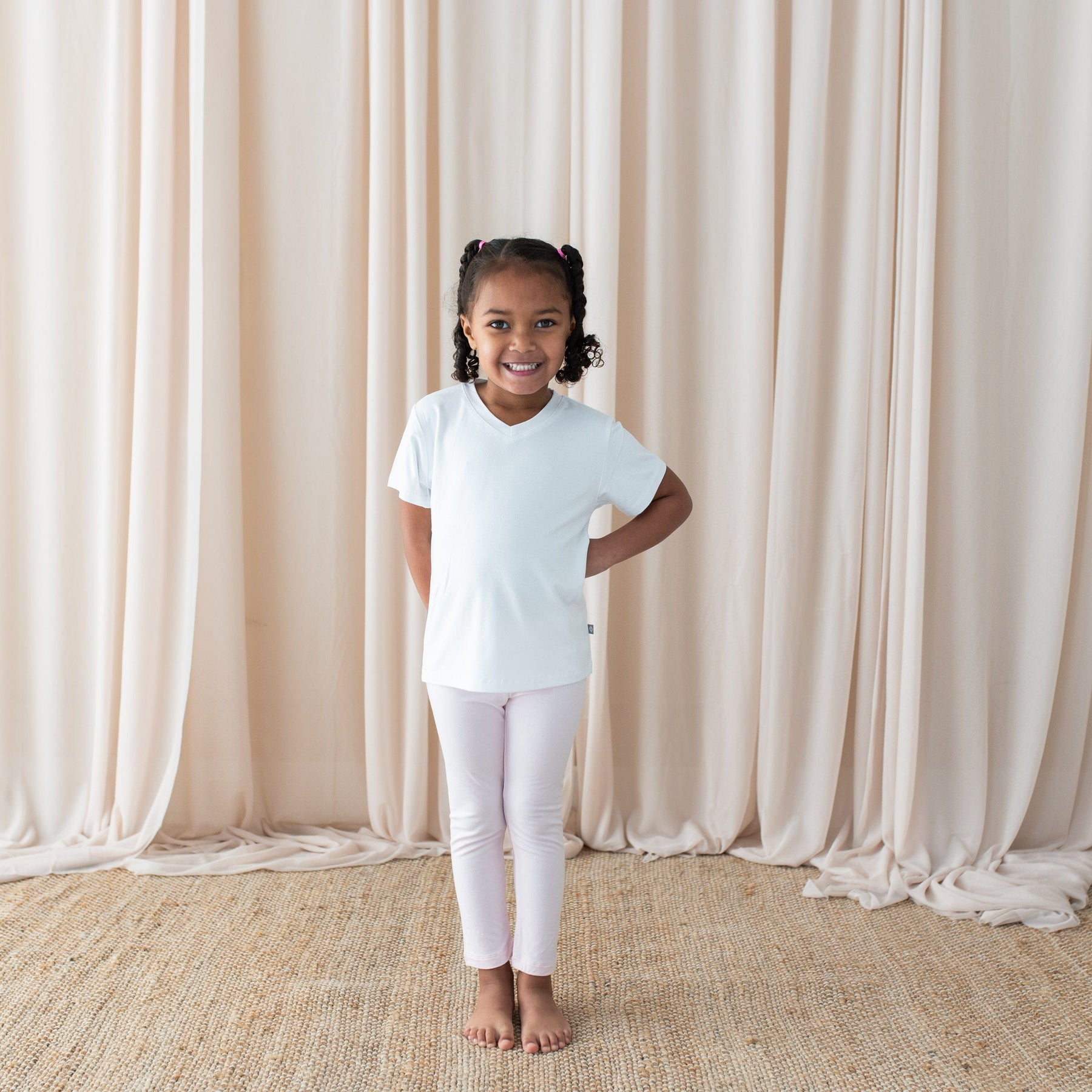 Girl wearing Kyte Baby Toddler Leggings in Sakura