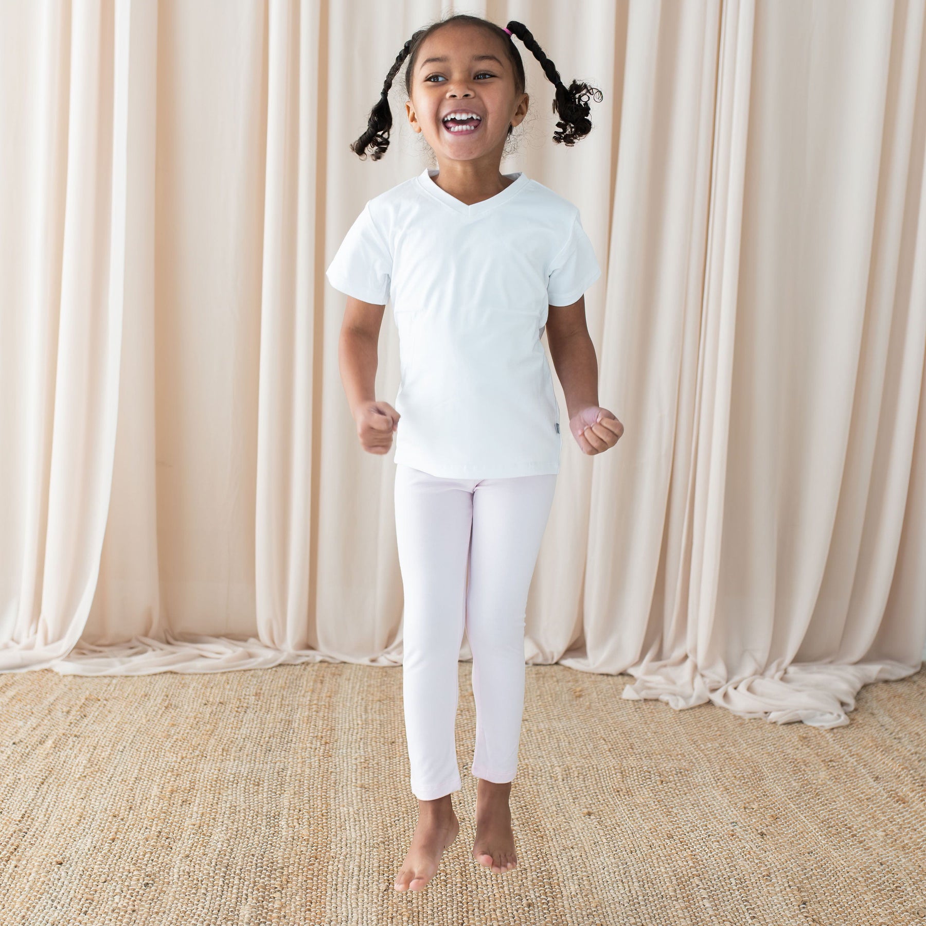 Child wearing Kyte Baby Bamboo Toddler Leggings in Sakura