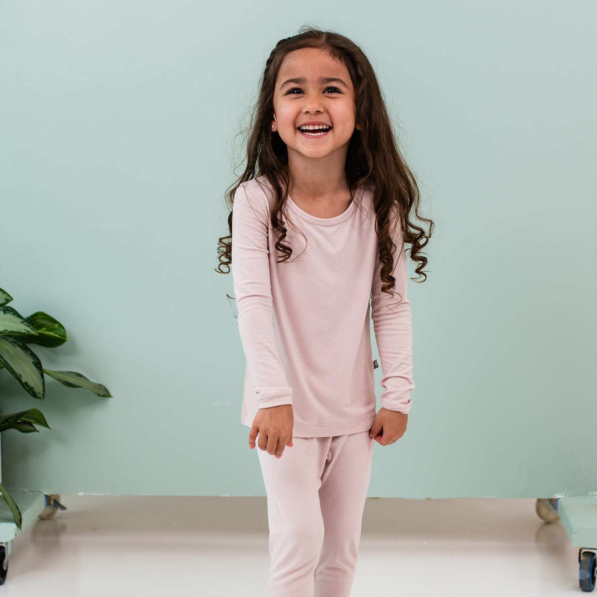 Child wearing Kyte Baby  Long Sleeve Pajamas in Blush