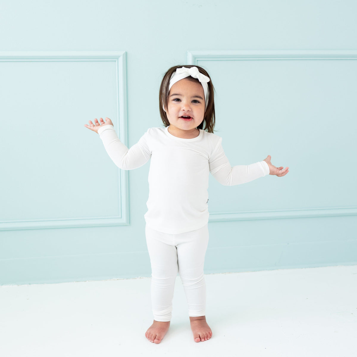 Toddler wearing Long Sleeve Pajamas in Cloud  and matching bow headband